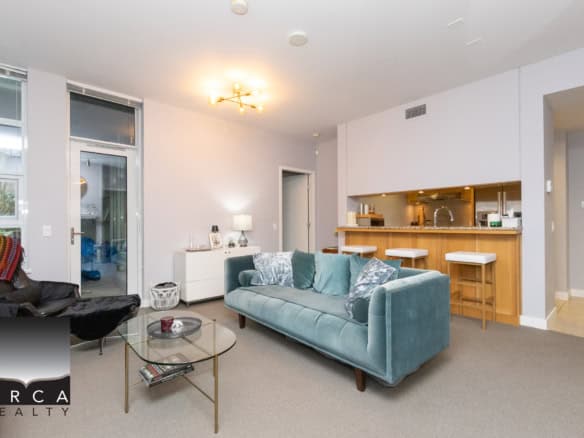 Bright and spacious living room in a Vancouver condo featuring contemporary furniture and open-plan design. Perfect for relaxing or entertaining guests in a stylish urban setting.