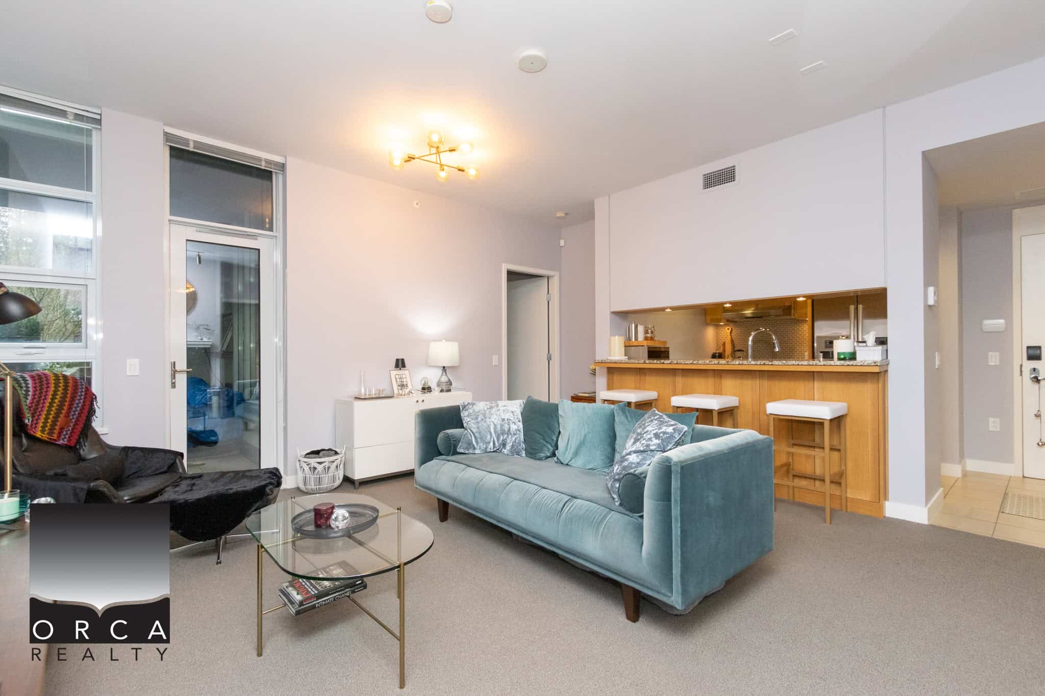 Bright and spacious living room in a Vancouver condo featuring contemporary furniture and open-plan design. Perfect for relaxing or entertaining guests in a stylish urban setting.