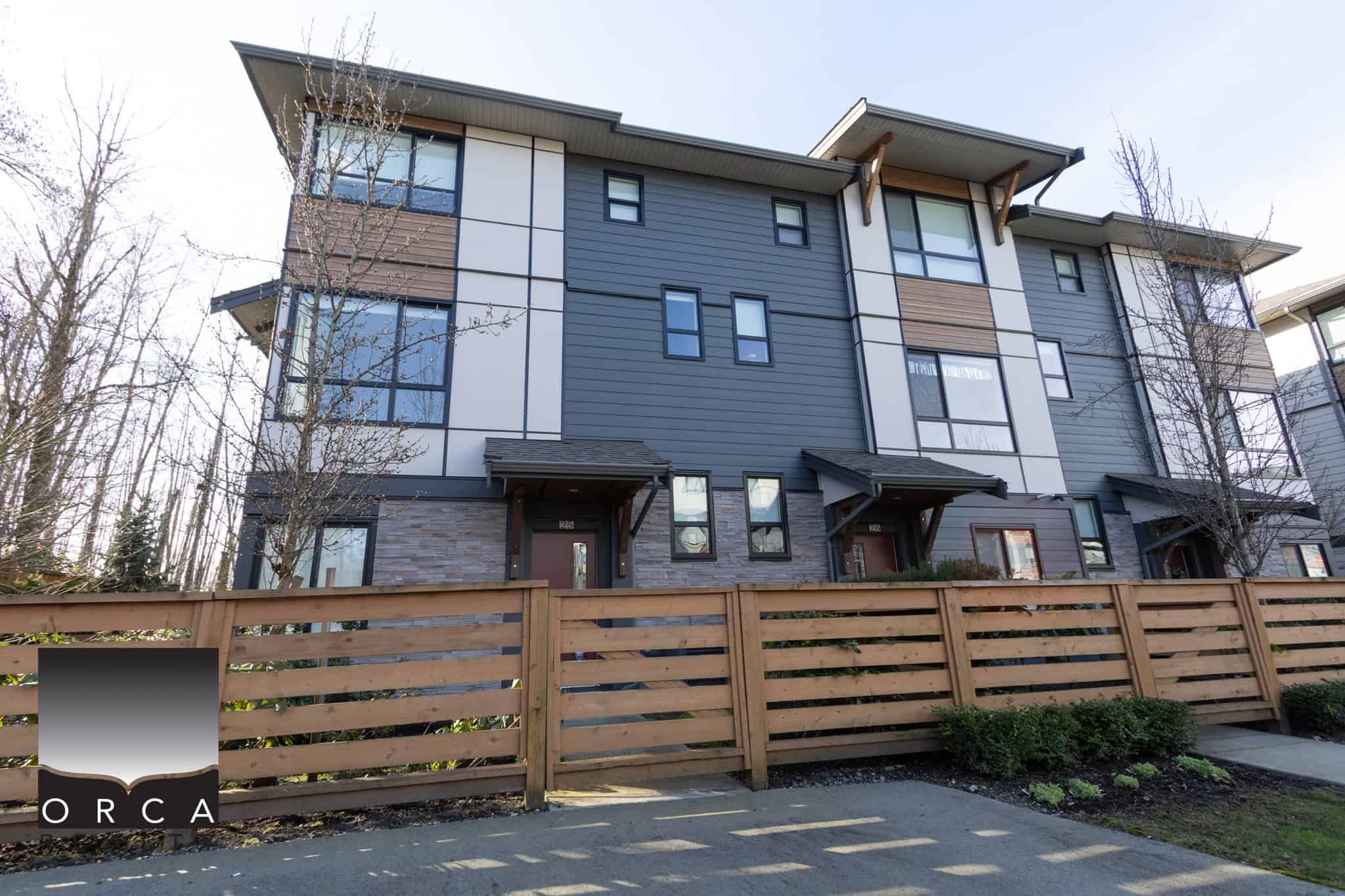 Contemporary multi-family home with stylish exterior, large windows, and private entrance, ideal for families or investors in Langley.