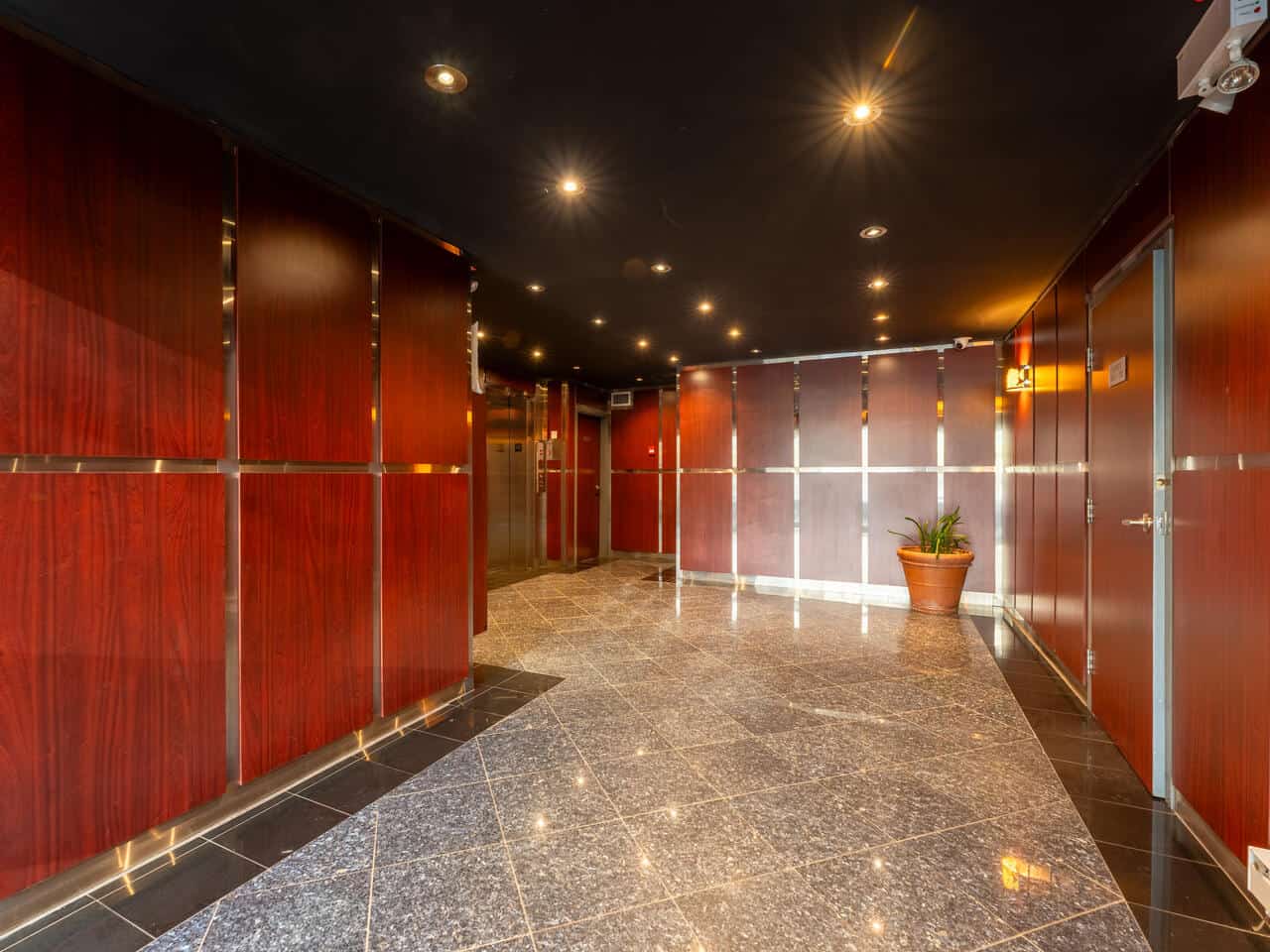 Elegant office lobby with polished floors and warm wood paneling.