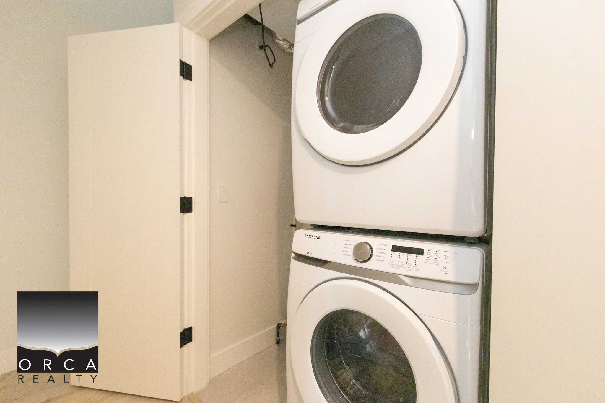 Stacked washer and dryer in a compact laundry space at 25-19918 75A Avenue, Langley, showcasing efficient use of space for convenient home living.