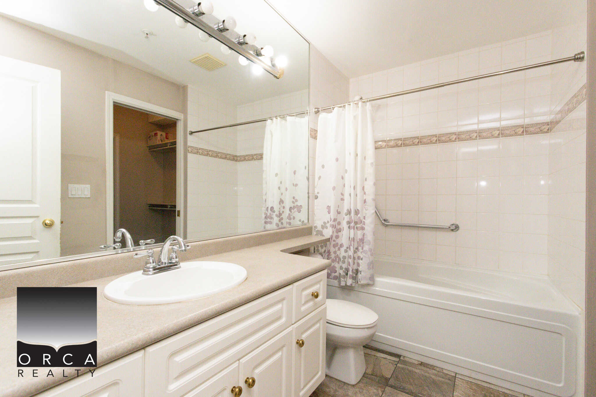 Bright bathroom with bathtub and shower, modern fixtures, and neutral decor in a Coquitlam property listed by Orca Realty Inc.