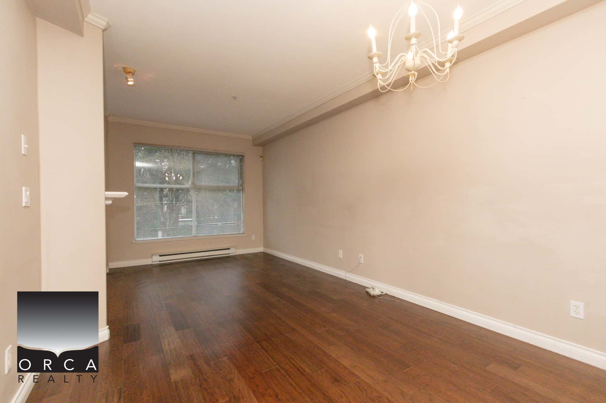 Bright and open living space with hardwood floors and large window in Coquitlam.
