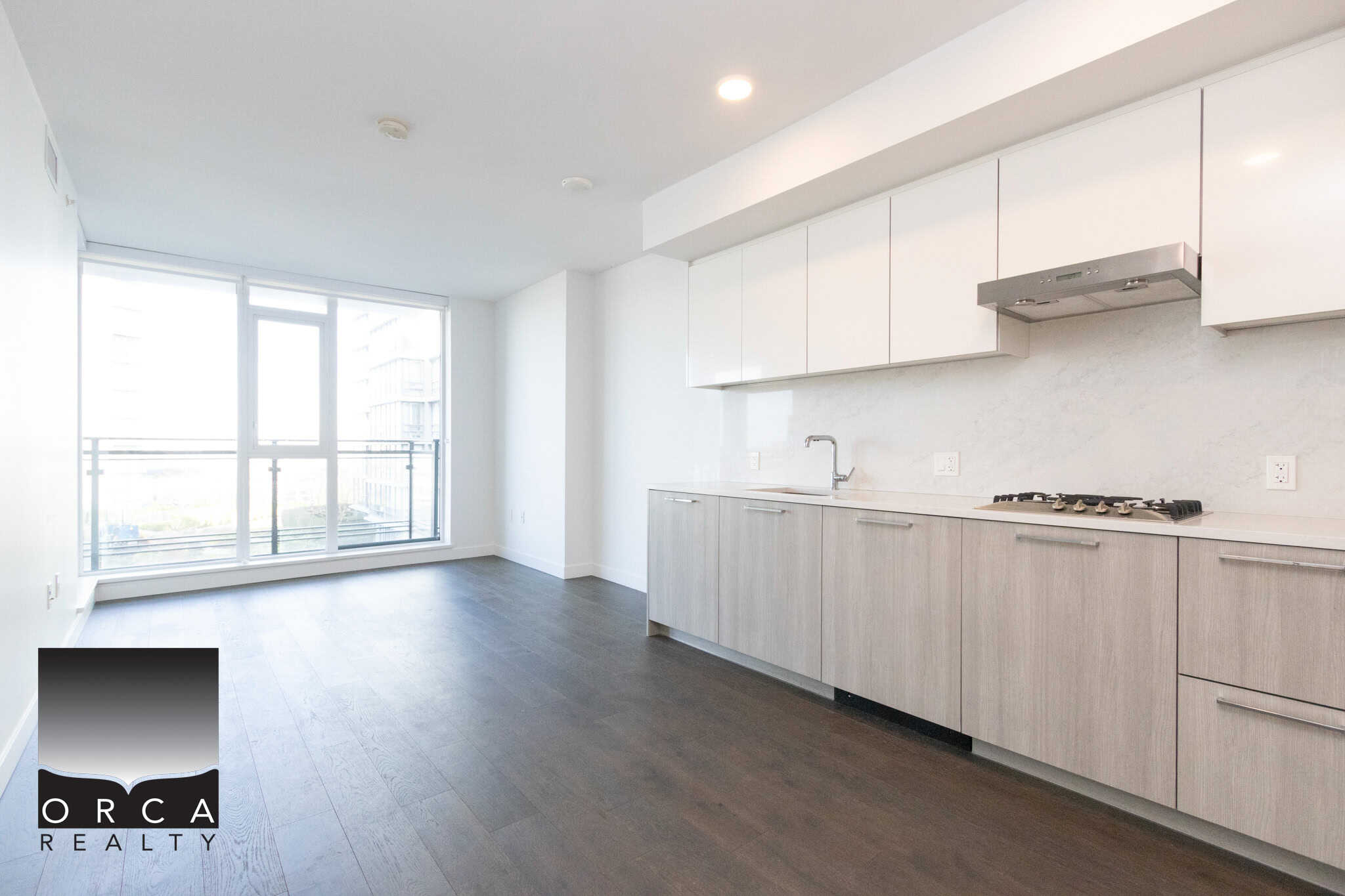 Modern Richmond Condo Kitchen with Large Windows Bright and spacious kitchen in a Richmond condo featuring white cabinetry, stainless steel appliances, and ample natural light from large windows. Perfect for comfortable living and entertaining.