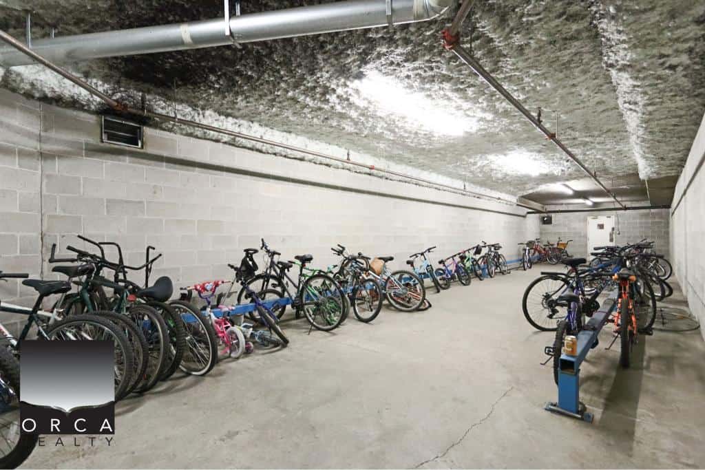 Underground bike storage area with multiple bicycles parked, showcasing secure and accessible parking facilities for residents.