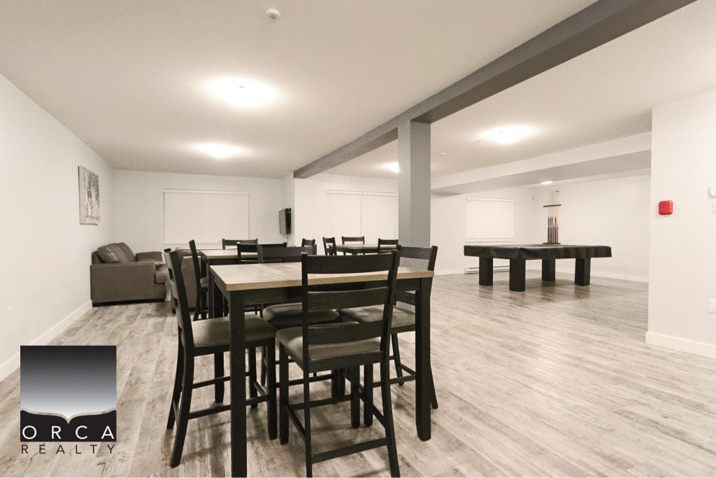 Spacious condo living room in Surrey with contemporary furniture and hardwood flooring.