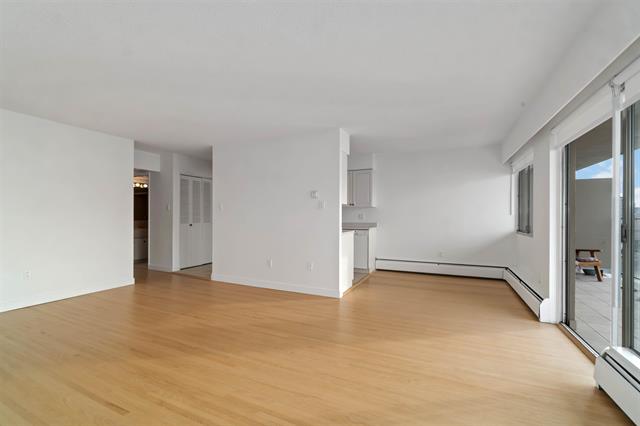 Bright and open living space in West Vancouver with hardwood floors and large windows. Perfect for family gatherings and entertaining guests.