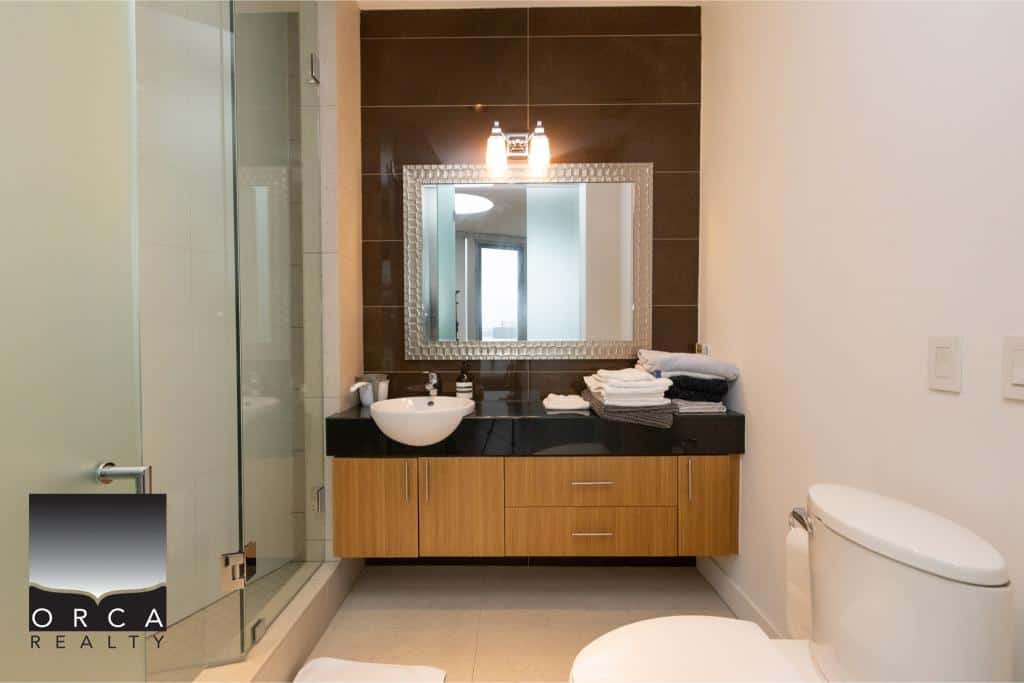 Stylish bathroom featuring a modern vanity, vessel sink, and elegant lighting, perfect for Ansell Place residences.