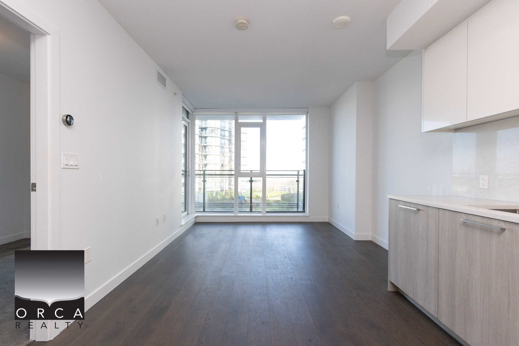 Modern Richmond Condo Interior Bright and spacious living area in a Richmond condo at 702E-3280 Corvee Way, featuring large windows and contemporary finishes. Perfect for comfortable urban living.