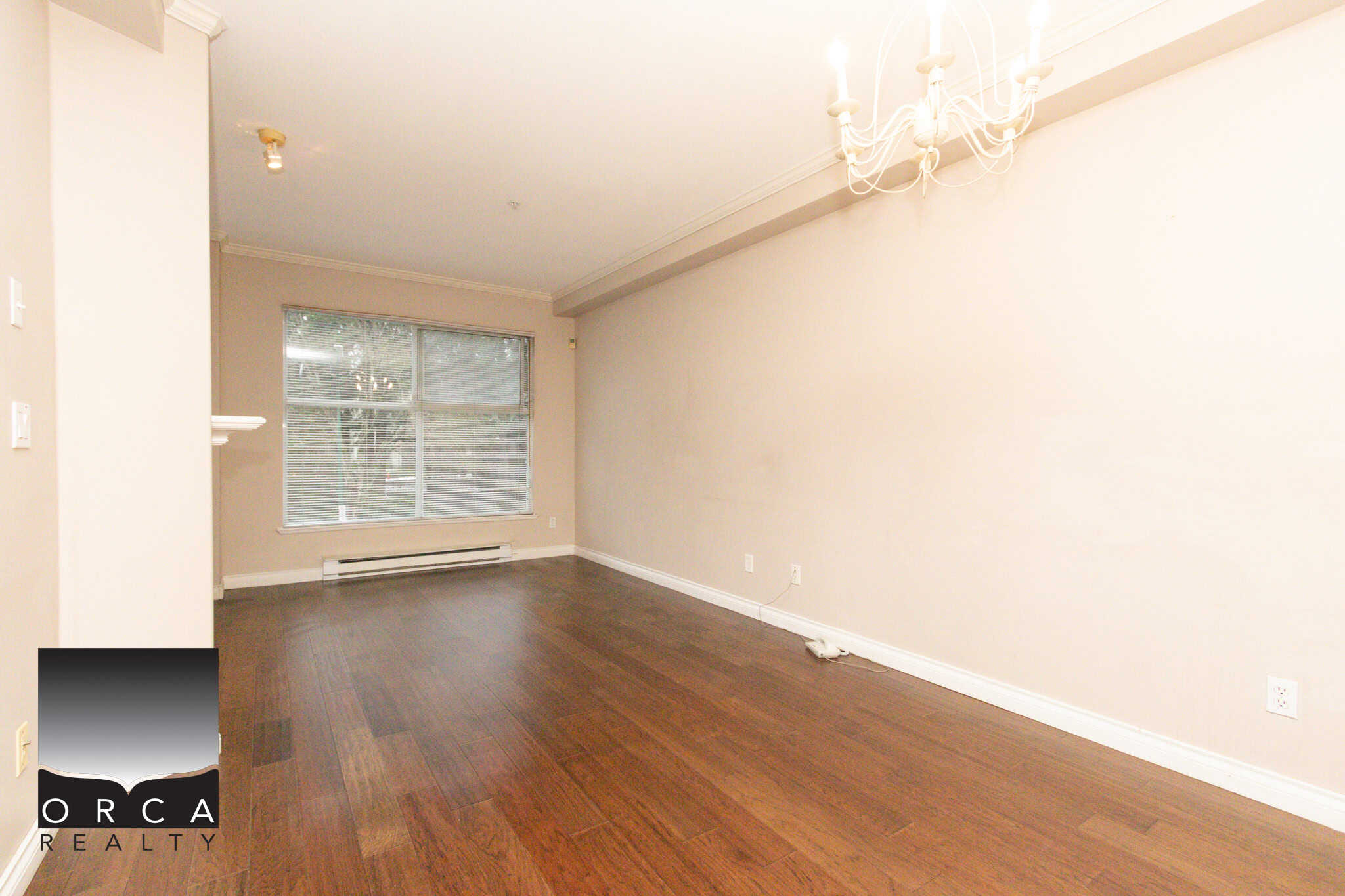 Bright and open living space in Coquitlam with hardwood floors and large window views.