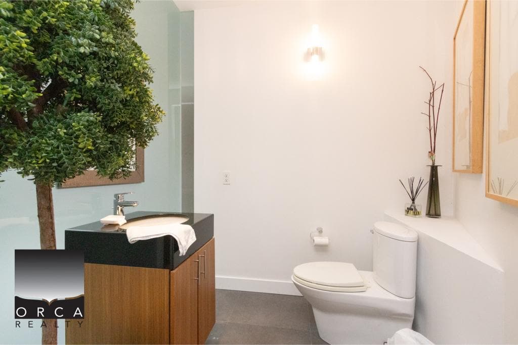 Modern bathroom featuring a sleek toilet and stylish vanity with a sink, perfect for contemporary living spaces at Ansell Place.