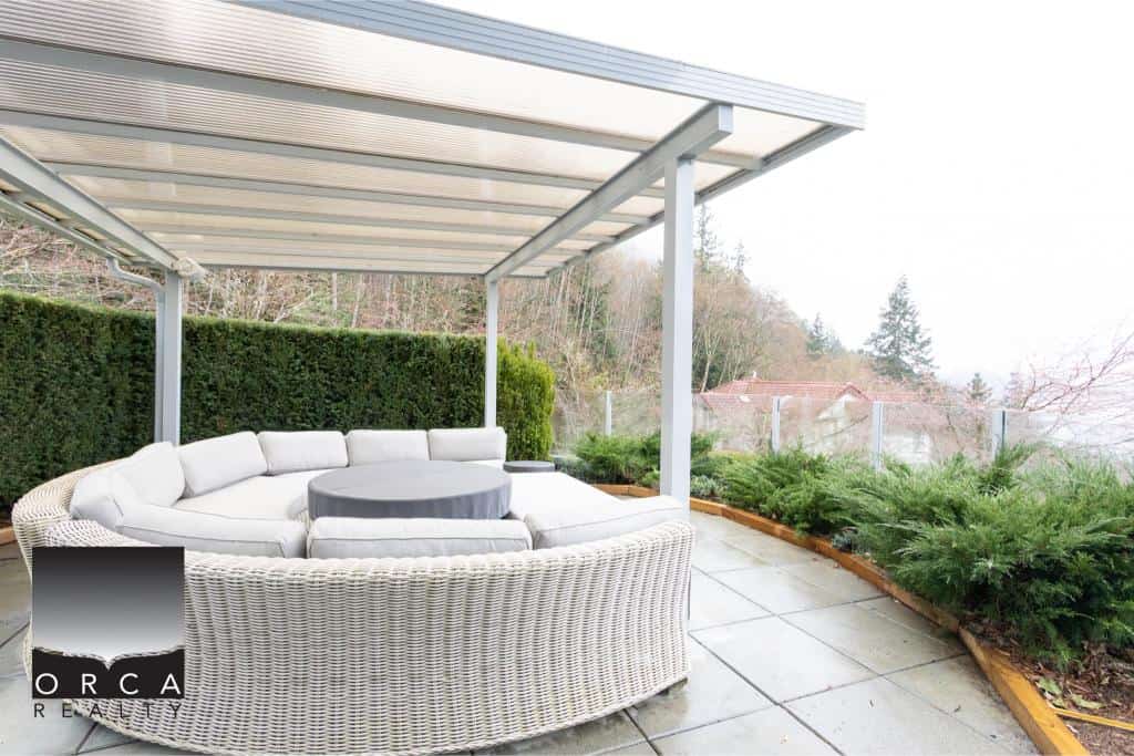 Outdoor patio with modern seating and a covered pergola at Ansell Place.