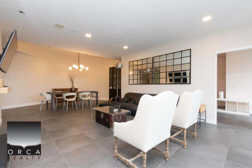 Spacious Ansell Place living room featuring stylish furniture, contemporary lighting, and a sleek design, perfect for relaxing or entertaining guests in a sophisticated setting.