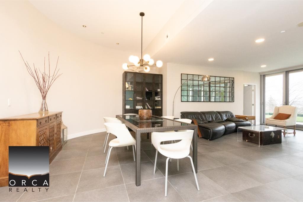 Spacious and stylish interior featuring contemporary furniture, large windows, and elegant decor, perfect for modern urban living in Toronto.