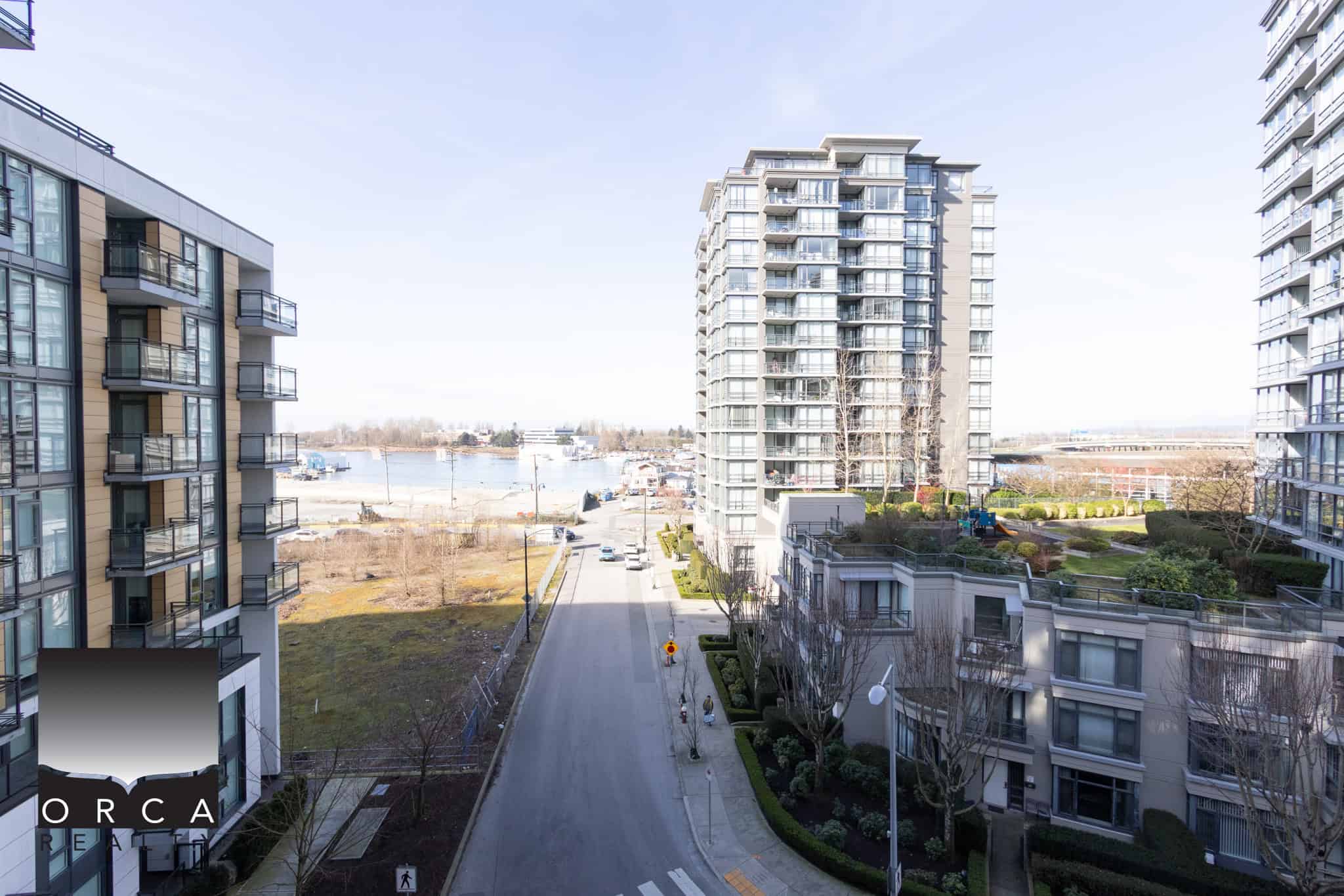 Modern Richmond Waterfront Condos Bright view of Richmond waterfront with high-rise residential buildings and marina in the background.