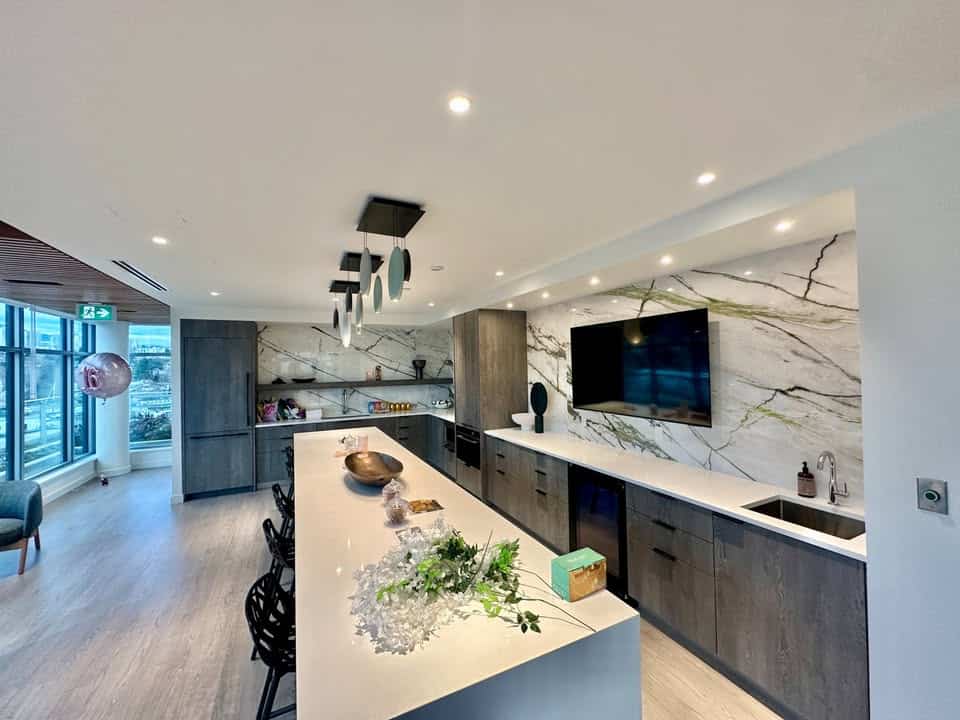 Spacious kitchen in a North Vancouver condo at 501-755 Harbourside Drive, showcasing contemporary design, sleek cabinetry, and modern appliances, perfect for stylish living.