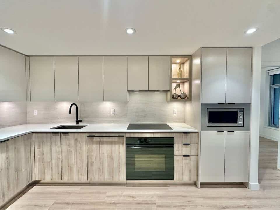 Contemporary kitchen design in North Vancouver featuring minimalist cabinetry, integrated microwave, and spacious countertops, perfect for modern living.