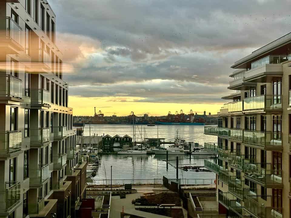 Beautiful waterfront view of Harbourside Drive in North Vancouver with modern residential buildings and marina.