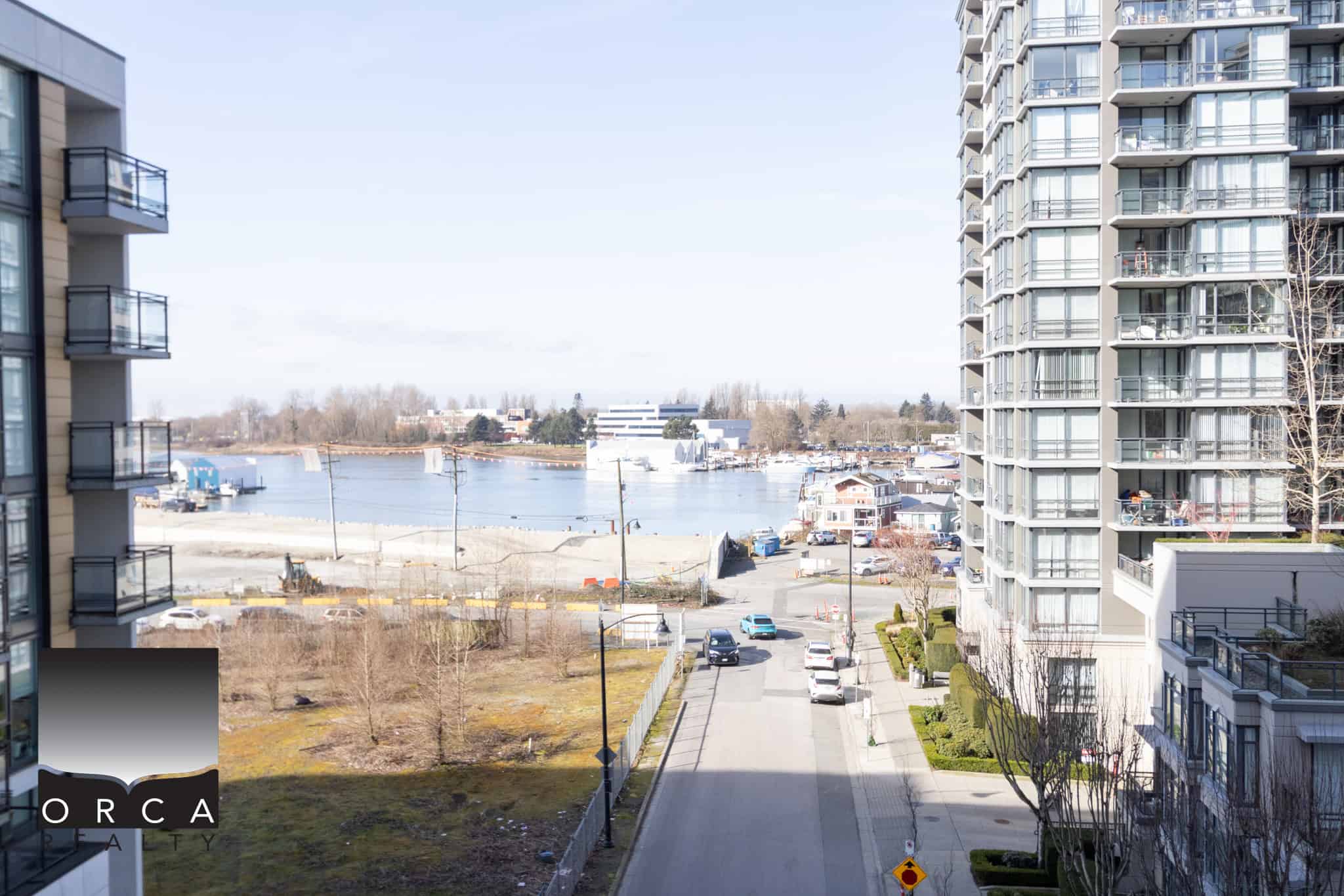Waterfront view from Corvee Way, Richmond with modern high-rise buildings. Stunning waterfront view from Corvee Way in Richmond, showcasing high-rise apartments and scenic waterway, ideal for real estate investment and waterfront living.