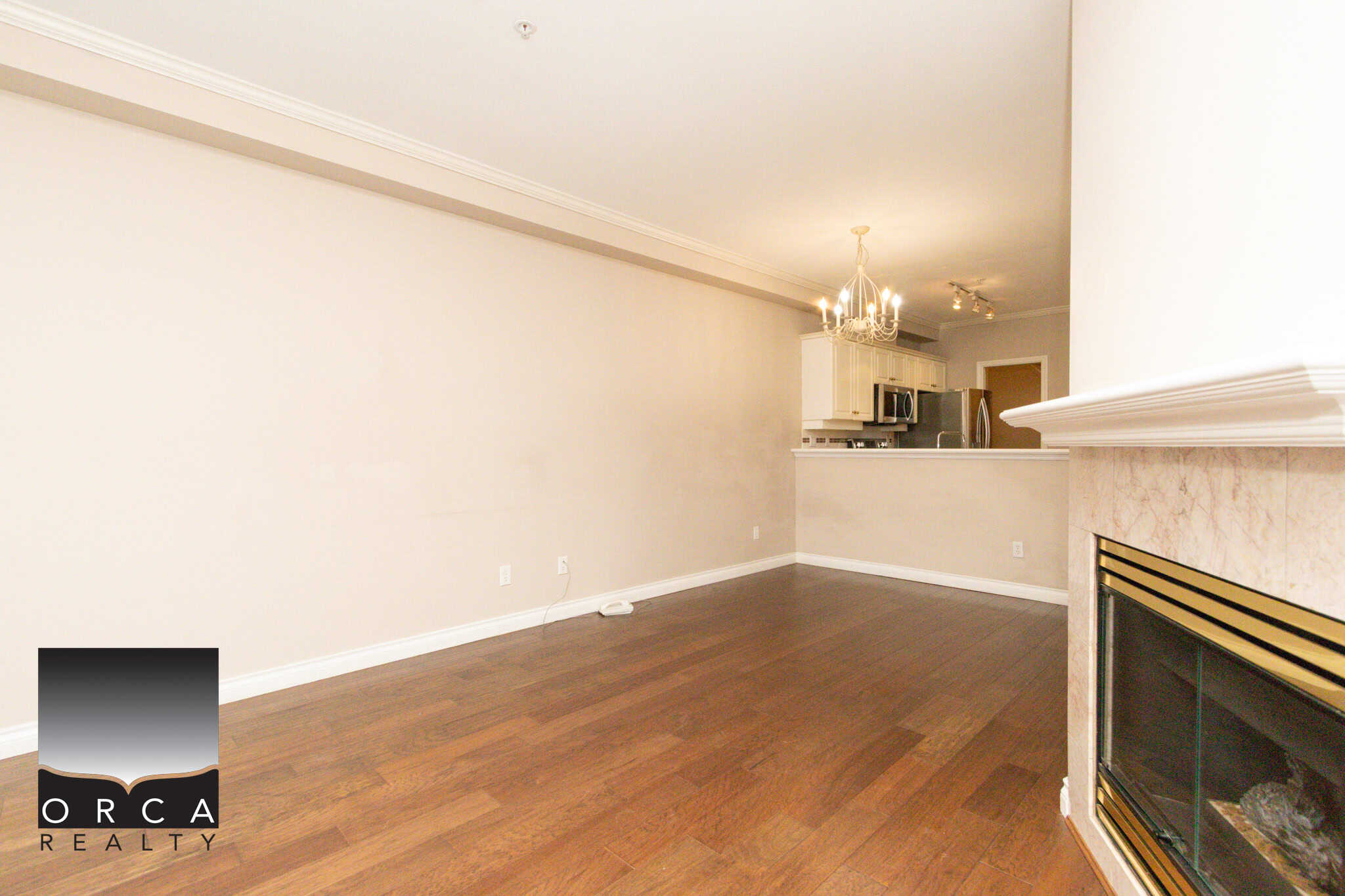 Bright and open living space in Coquitlam, ideal for family living or entertaining guests. Features hardwood floors, a cozy fireplace, and modern kitchen access.