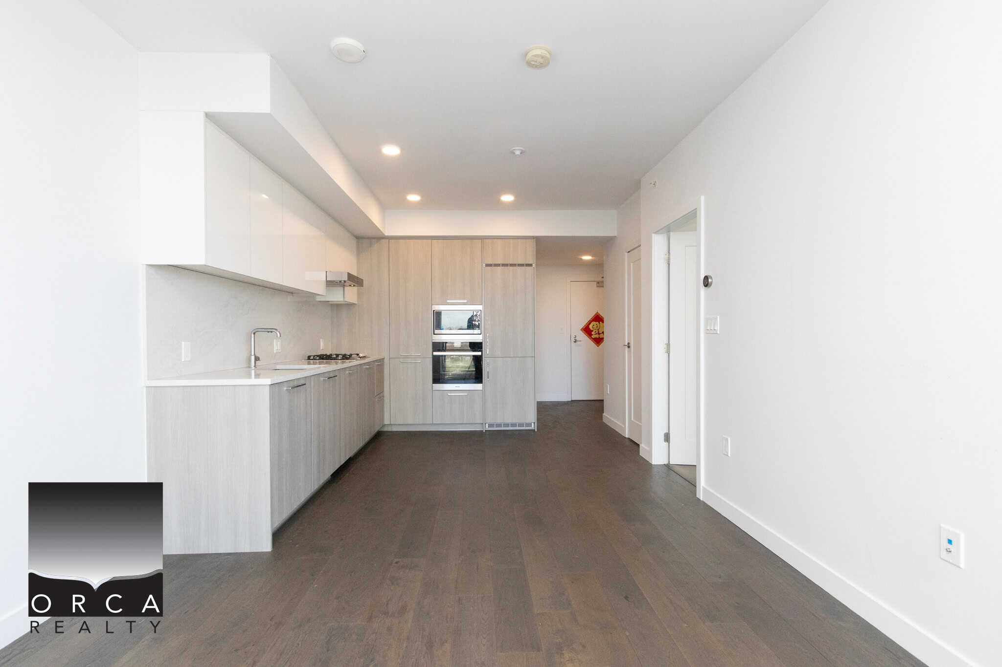 Modern kitchen interior at 702E-3280 Corvee Way, Richmond. Bright, open-concept kitchen with sleek cabinetry and stainless steel appliances in a contemporary home.