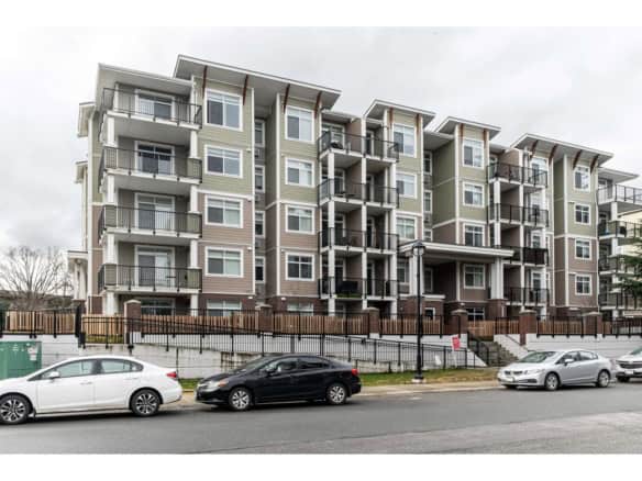 Modern apartment building in Langley with multiple balconies and large windows.