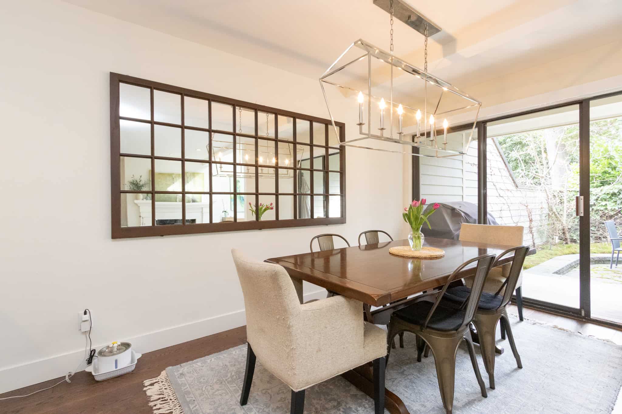 Modern West Vancouver Dining Room with Natural Light Bright dining area in West Vancouver featuring a wooden table, stylish chairs, and large windows overlooking a lush garden. Perfect for family gatherings and entertaining guests.