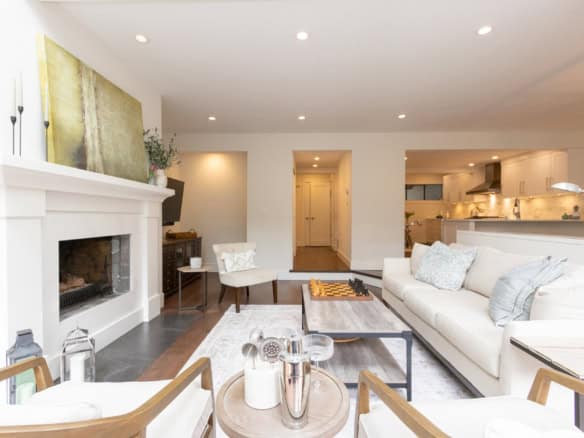 Modern West Vancouver living room with contemporary furniture and cozy fireplace.