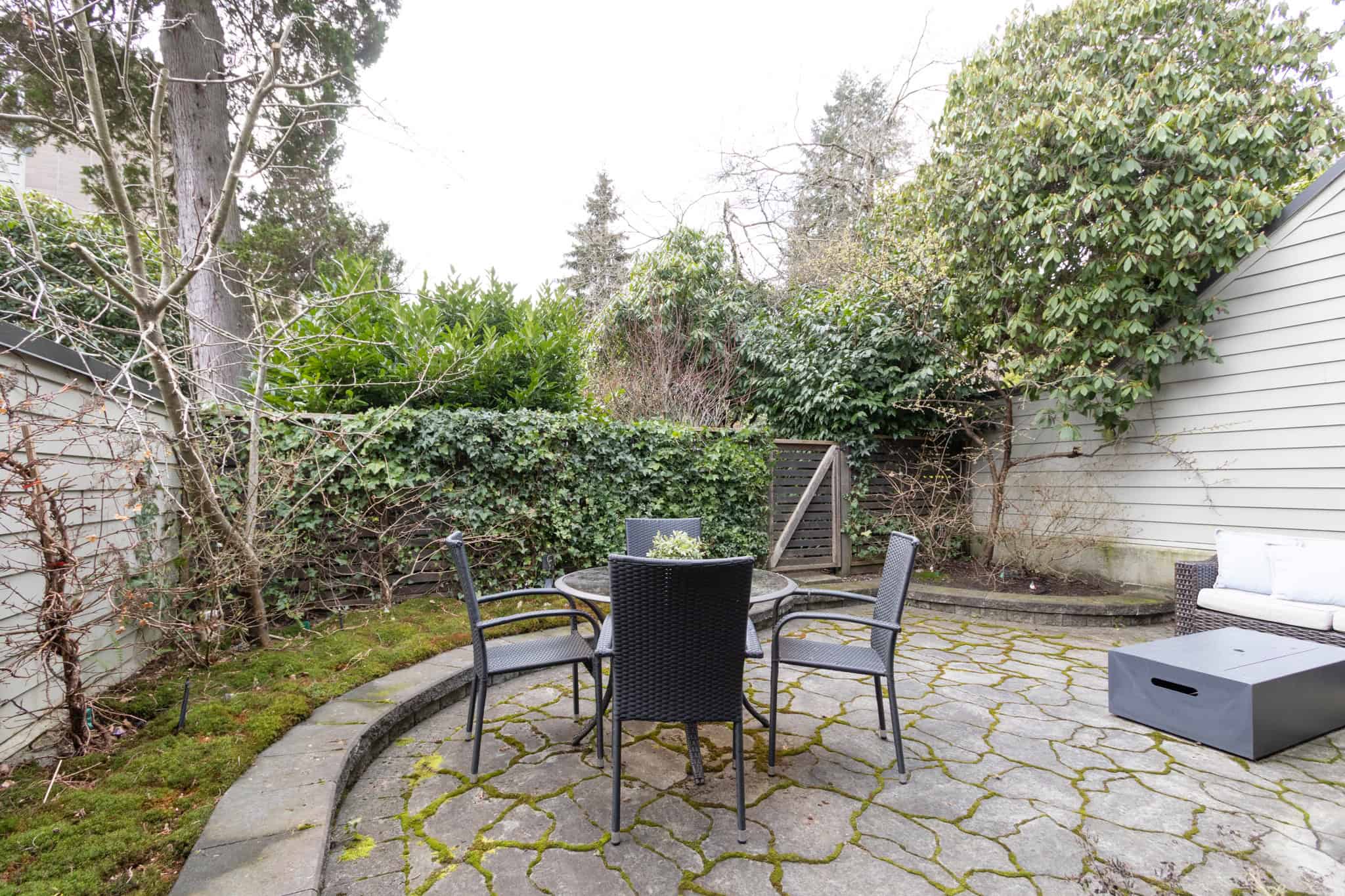 Cozy West Vancouver Backyard Patio Outdoor patio with garden seating in West Vancouver, near 13-4957 Marine Drive. Perfect for relaxing or entertaining guests in a private, lush garden setting.