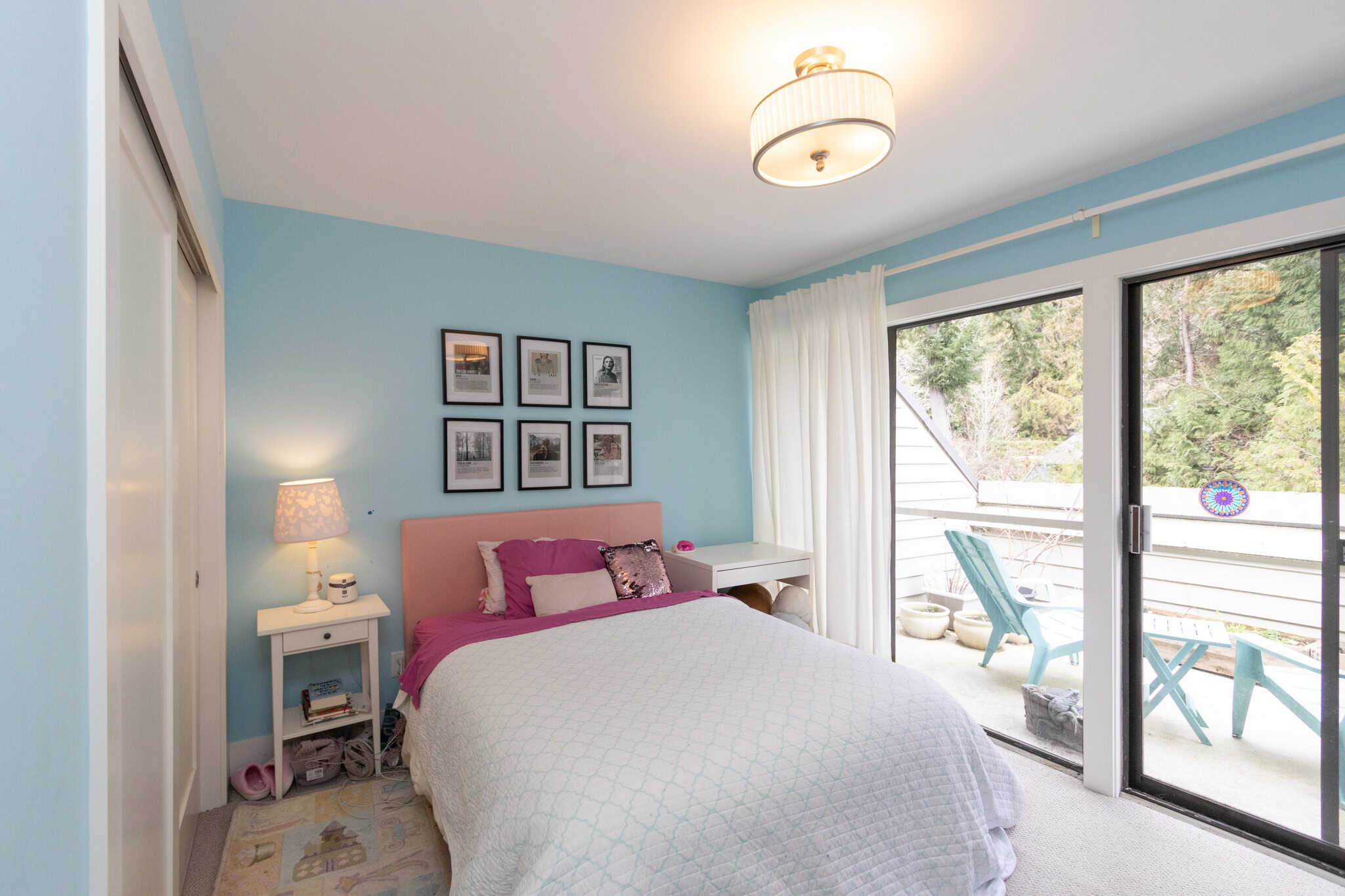 Cozy West Vancouver Bedroom with Balcony Bright West Vancouver bedroom featuring a comfortable bed, stylish decor, and access to a private balcony with outdoor seating. Perfect for relaxing and enjoying scenic views.