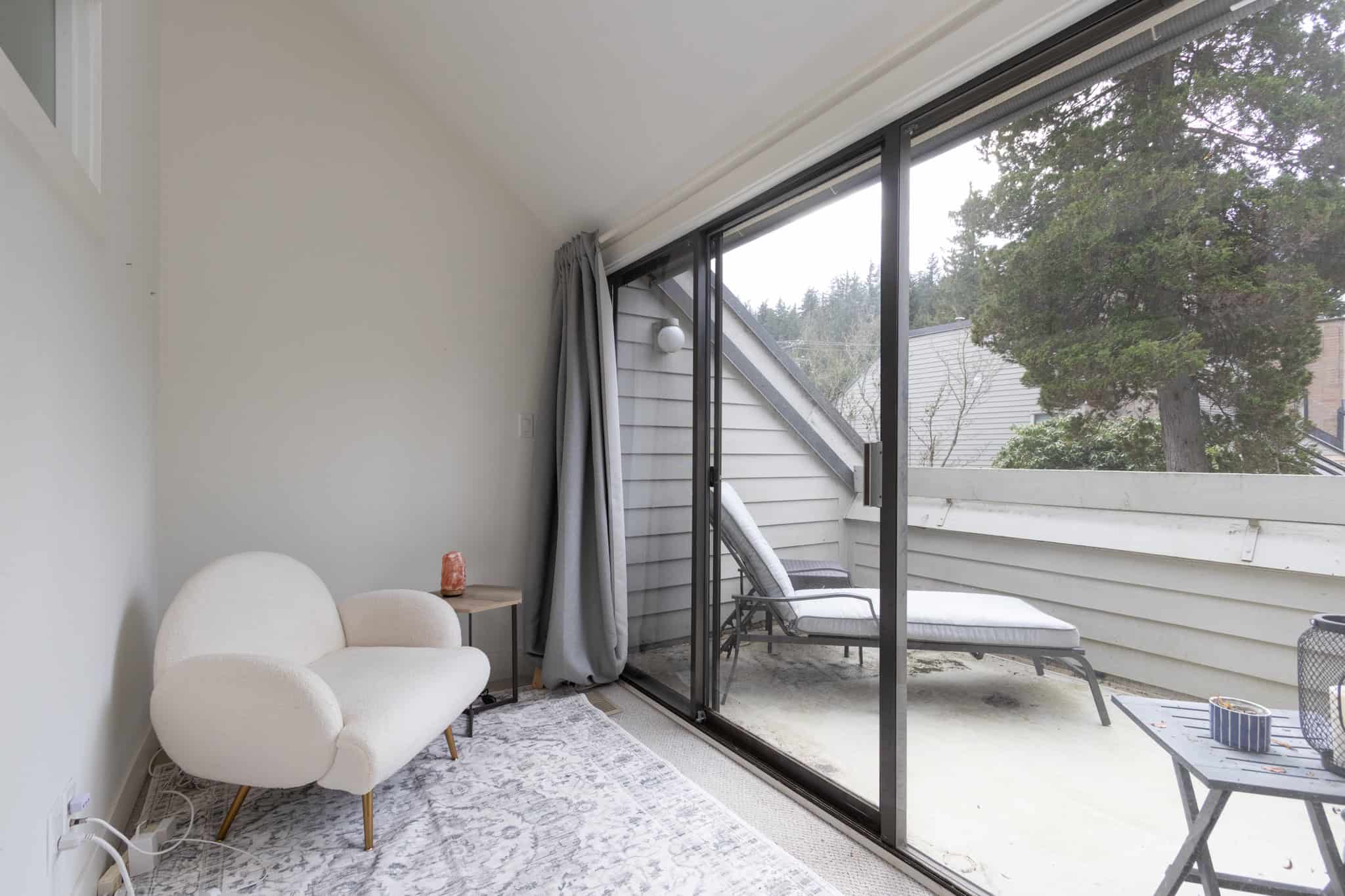 Modern West Vancouver balcony with outdoor seating and scenic views Bright West Vancouver balcony with outdoor lounge and garden views.