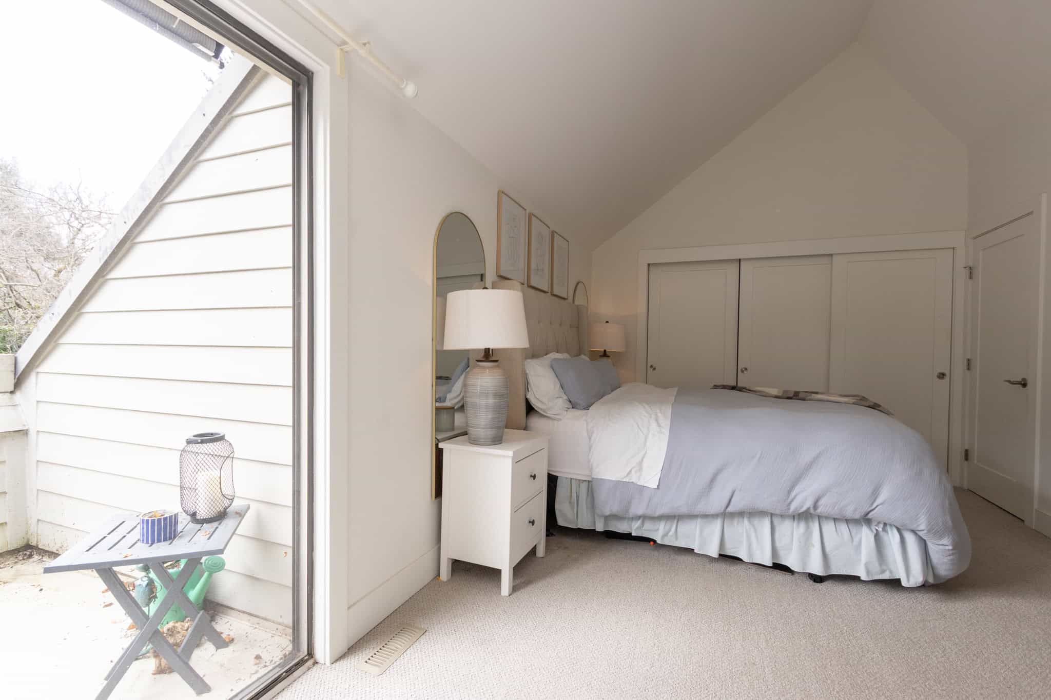 Charming West Vancouver Bedroom with Mountain View Bright bedroom in West Vancouver with large window showcasing scenic mountain views. Modern decor, cozy bed, and natural light create a welcoming atmosphere.