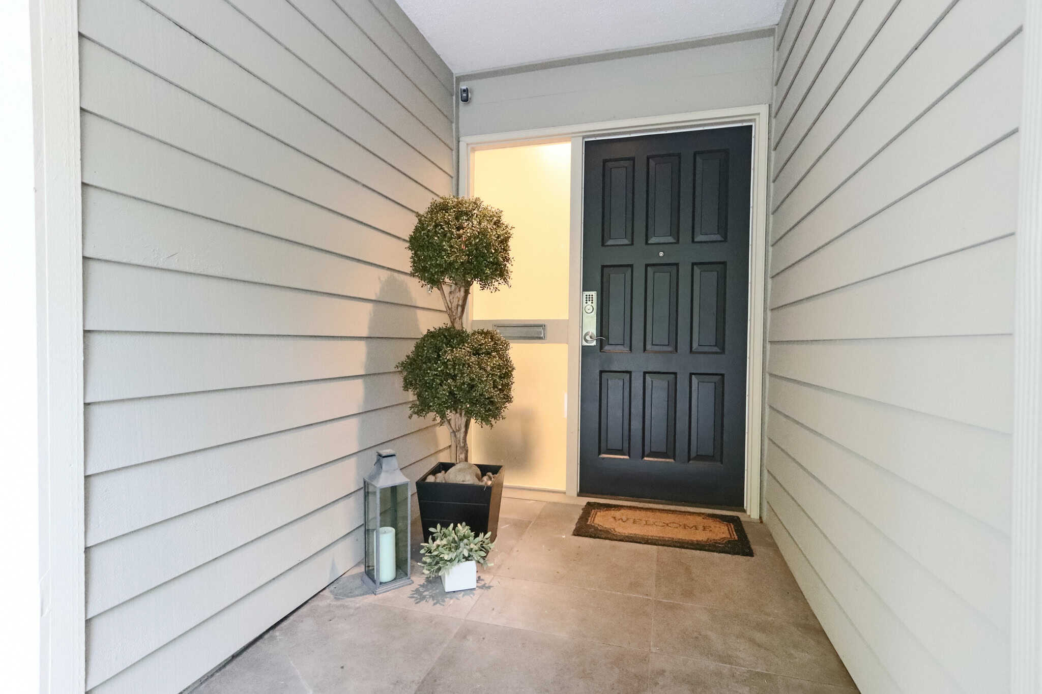 Charming West Vancouver Home Entrance Beautiful West Vancouver home entrance with modern black door and welcoming decor. Perfect for luxury real estate listings and showcasing upscale property features.