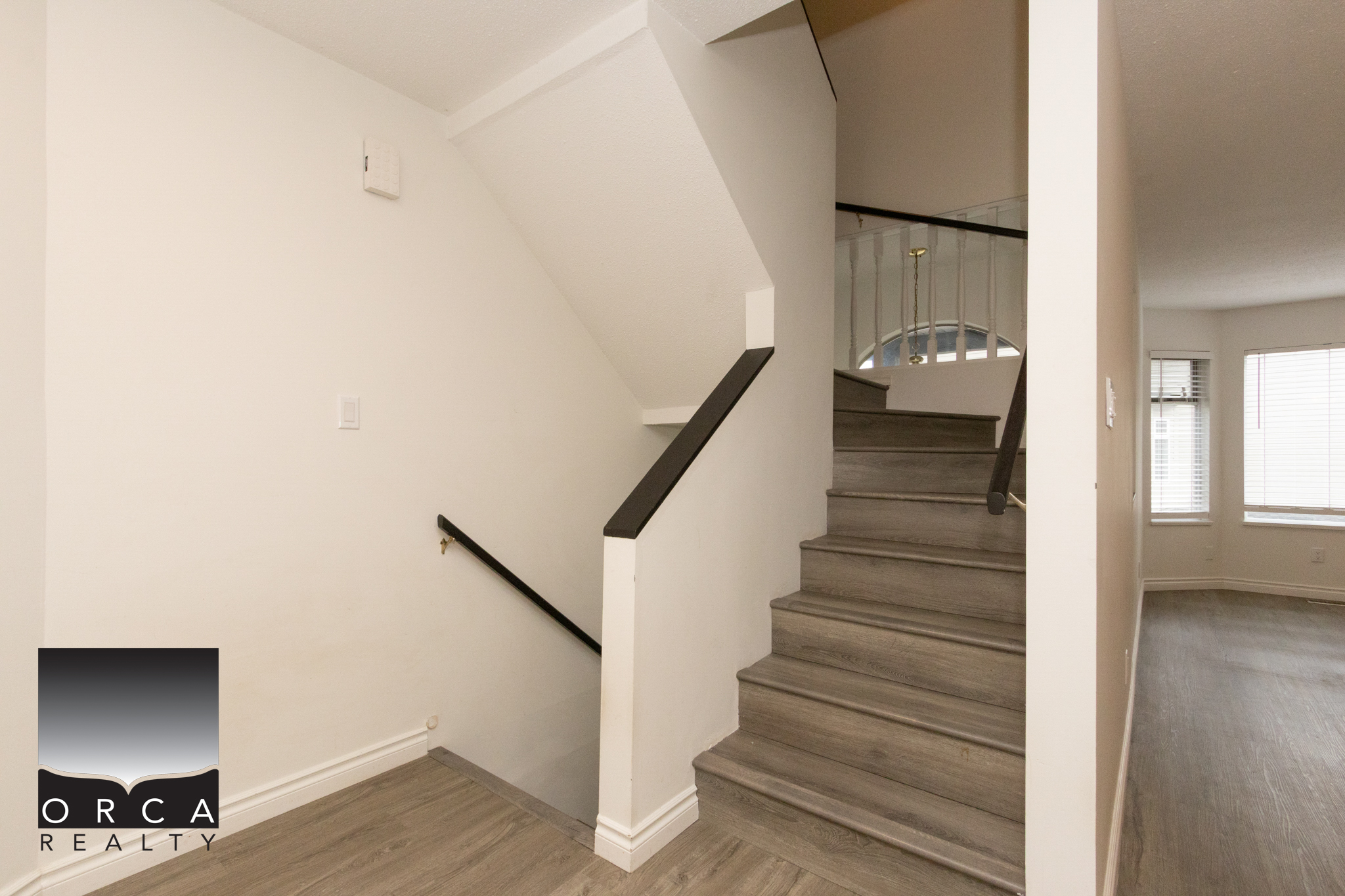Spacious staircase inside a contemporary home at 11-8751 Bennett Road, Richmond, showcasing clean design and neutral tones, perfect for modern living.