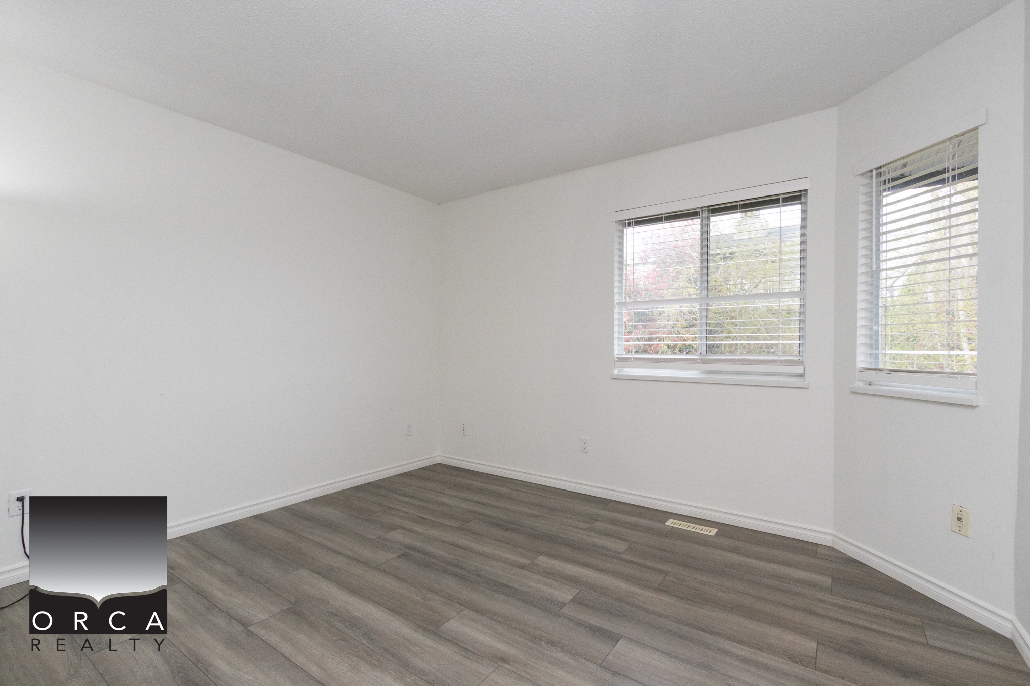 Bright and airy room in a Richmond property listed at 11-8751 Bennett Road, featuring modern flooring and large windows. Perfect for family living or entertaining guests.