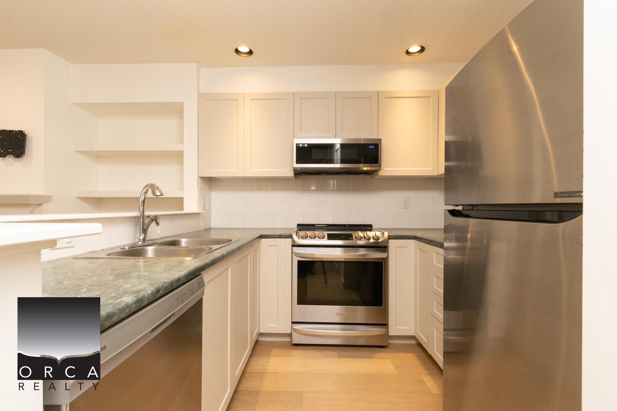 Bright, contemporary kitchen featuring stainless steel appliances and white cabinetry in Burnaby. Perfect for family living and entertaining in a desirable neighborhood.