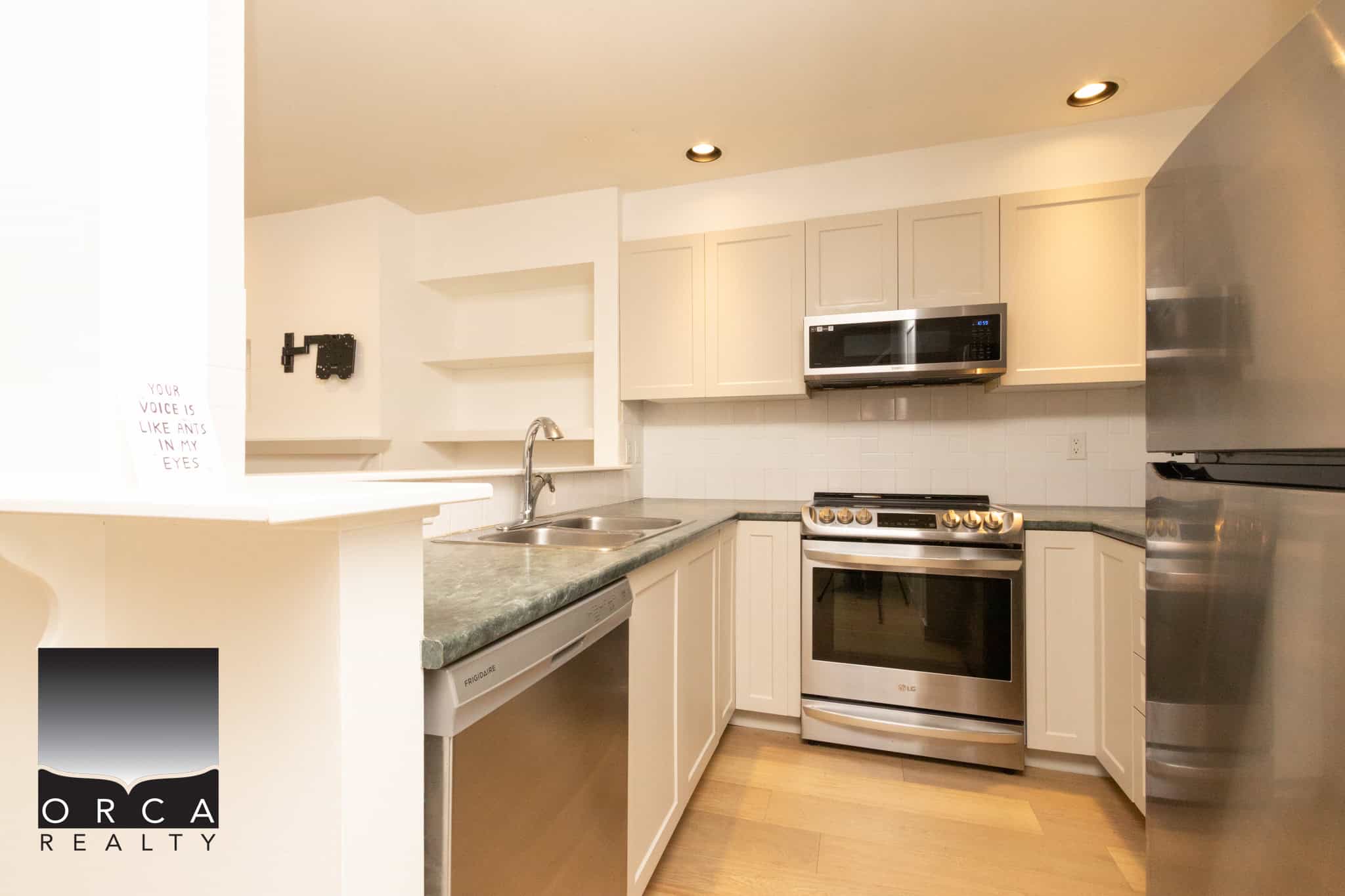 Modern kitchen with stainless steel appliances in Burnaby property for sale.