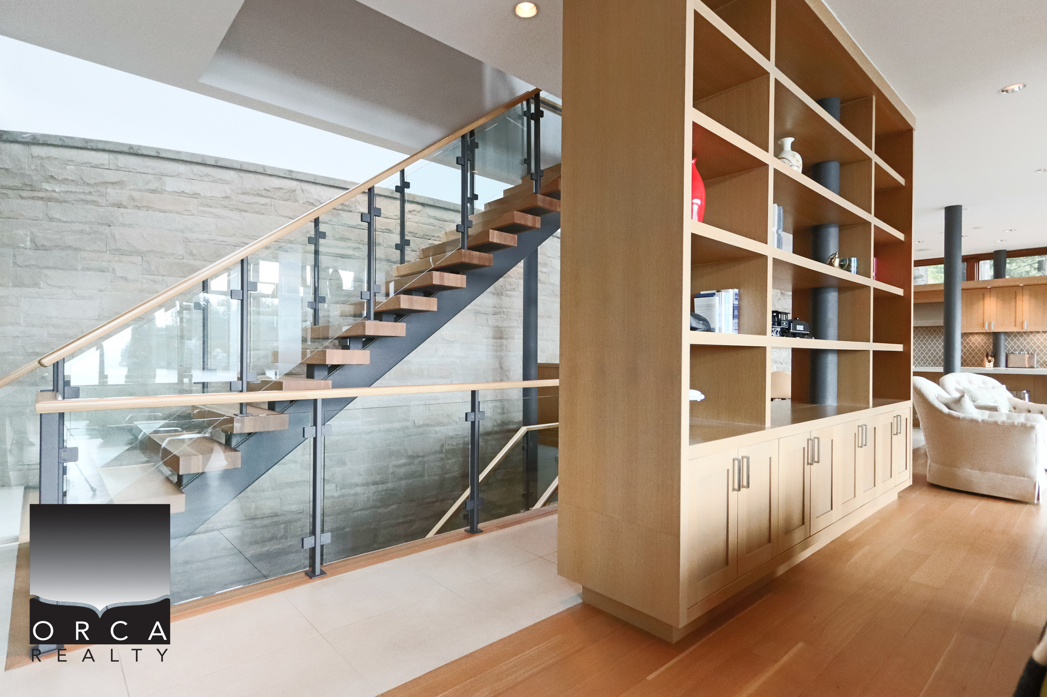 Modern interior staircase at 6780 Bachelor Bay Place, West Vancouver. Elegant staircase with glass railing and wooden steps in a contemporary home.