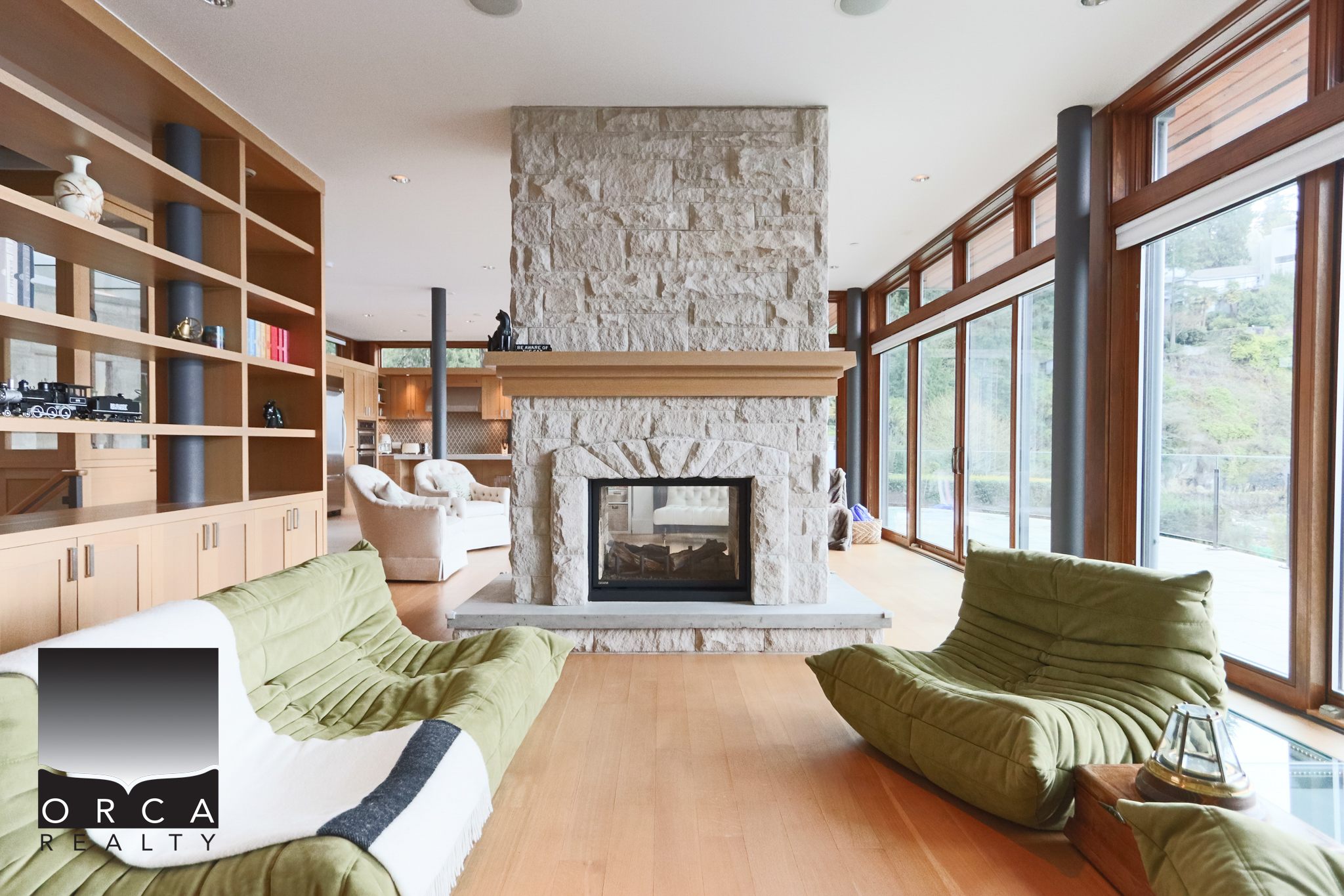 Modern Living Room with Fireplace in West Vancouver Spacious West Vancouver living room featuring a cozy fireplace, large windows with scenic views, and contemporary furniture, ideal for luxury home buyers.