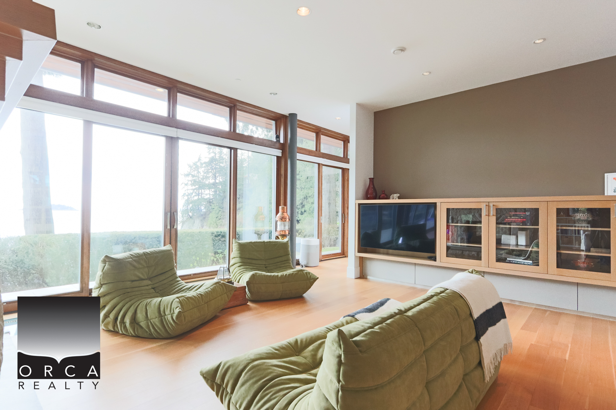 Modern West Vancouver Living Room with Large Windows Spacious living room in West Vancouver featuring large windows, natural light, and contemporary furniture, perfect for relaxing and enjoying scenic views.