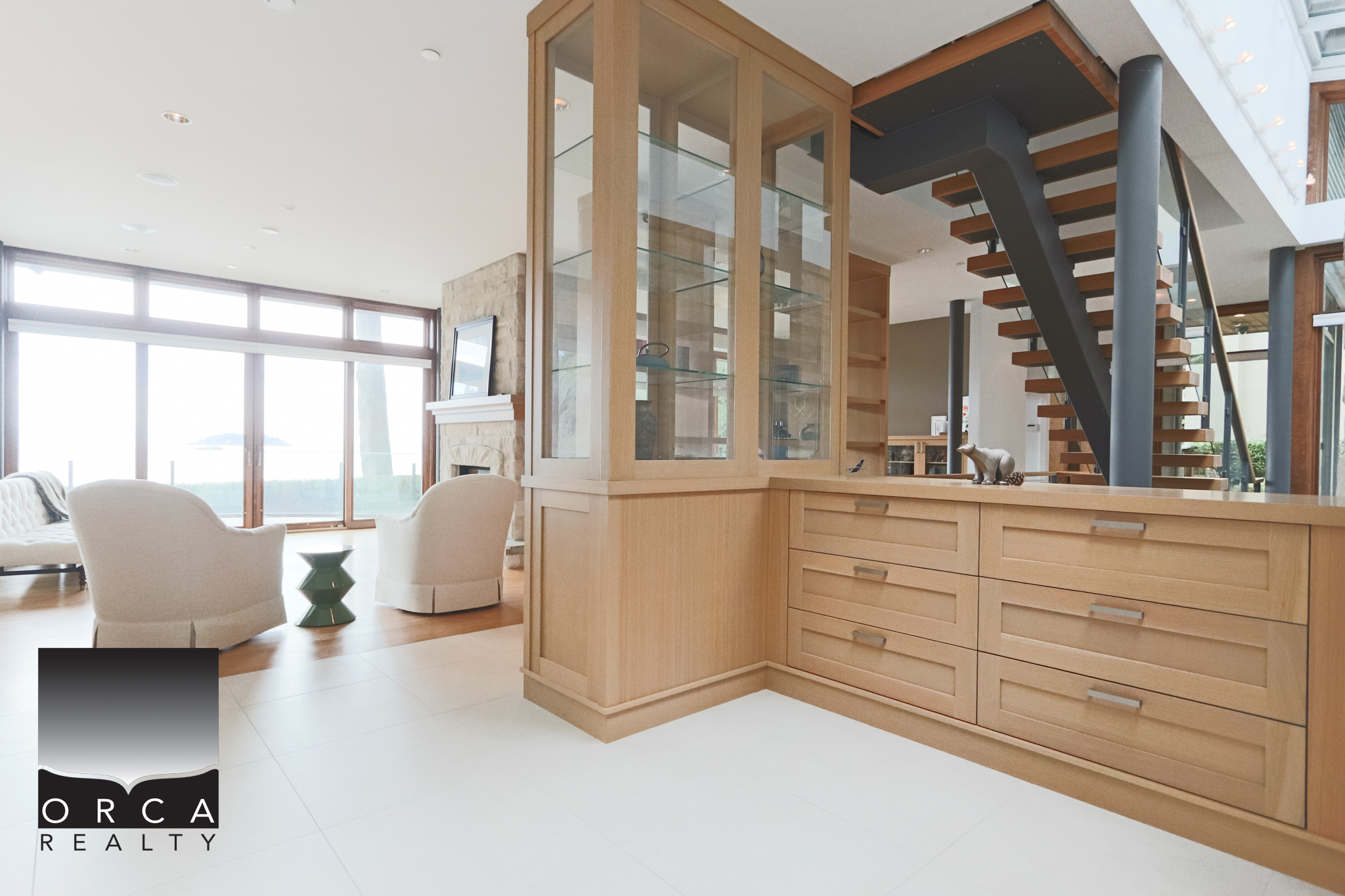 Modern West Vancouver Home Interior Contemporary interior view of a West Vancouver home showcasing natural wood cabinetry, open living space, and large windows with scenic views.