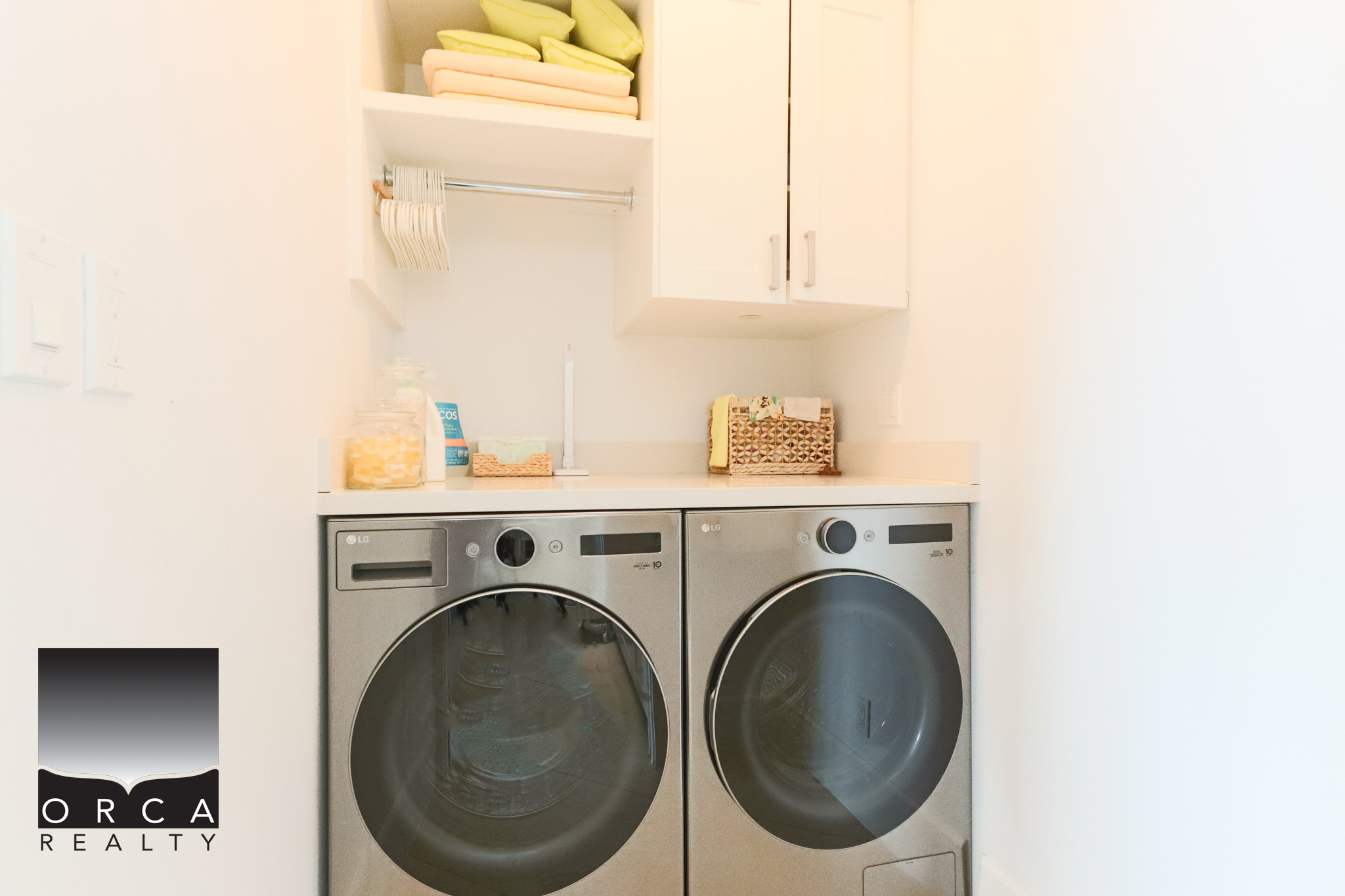Cozy Laundry Room in West Vancouver Bright laundry area with washer and dryer in a West Vancouver home. Clean, organized space featuring white cabinetry and storage solutions. Perfect for modern living.