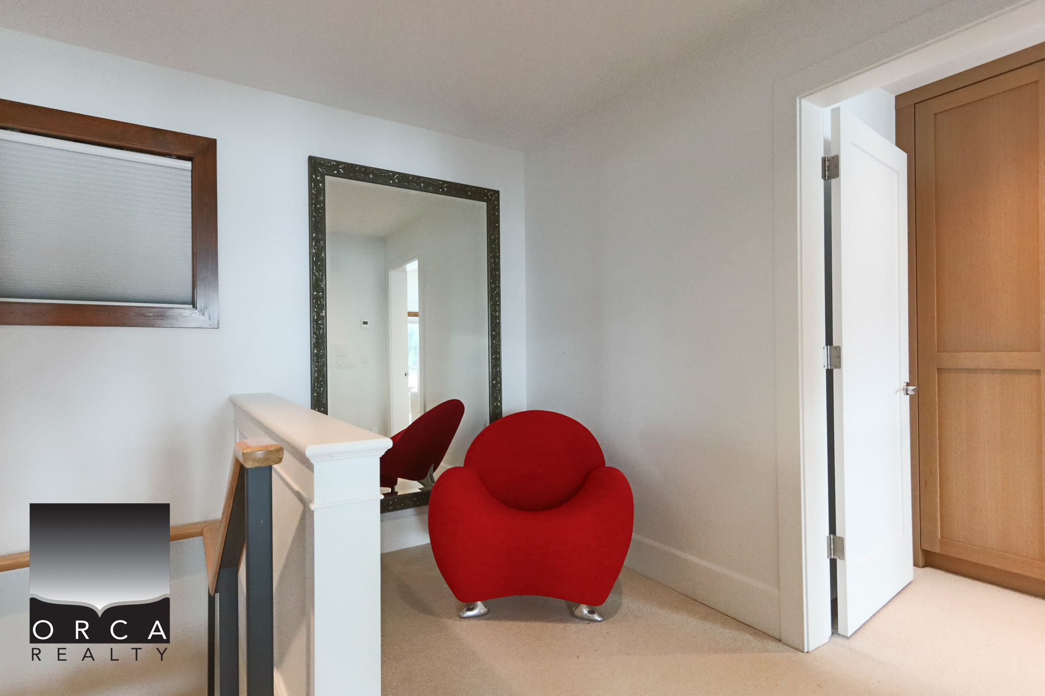 Charming Interior of West Vancouver Home Bright interior space featuring a red accent chair and a large mirror, perfect for a cozy reading nook or dressing area in West Vancouver.