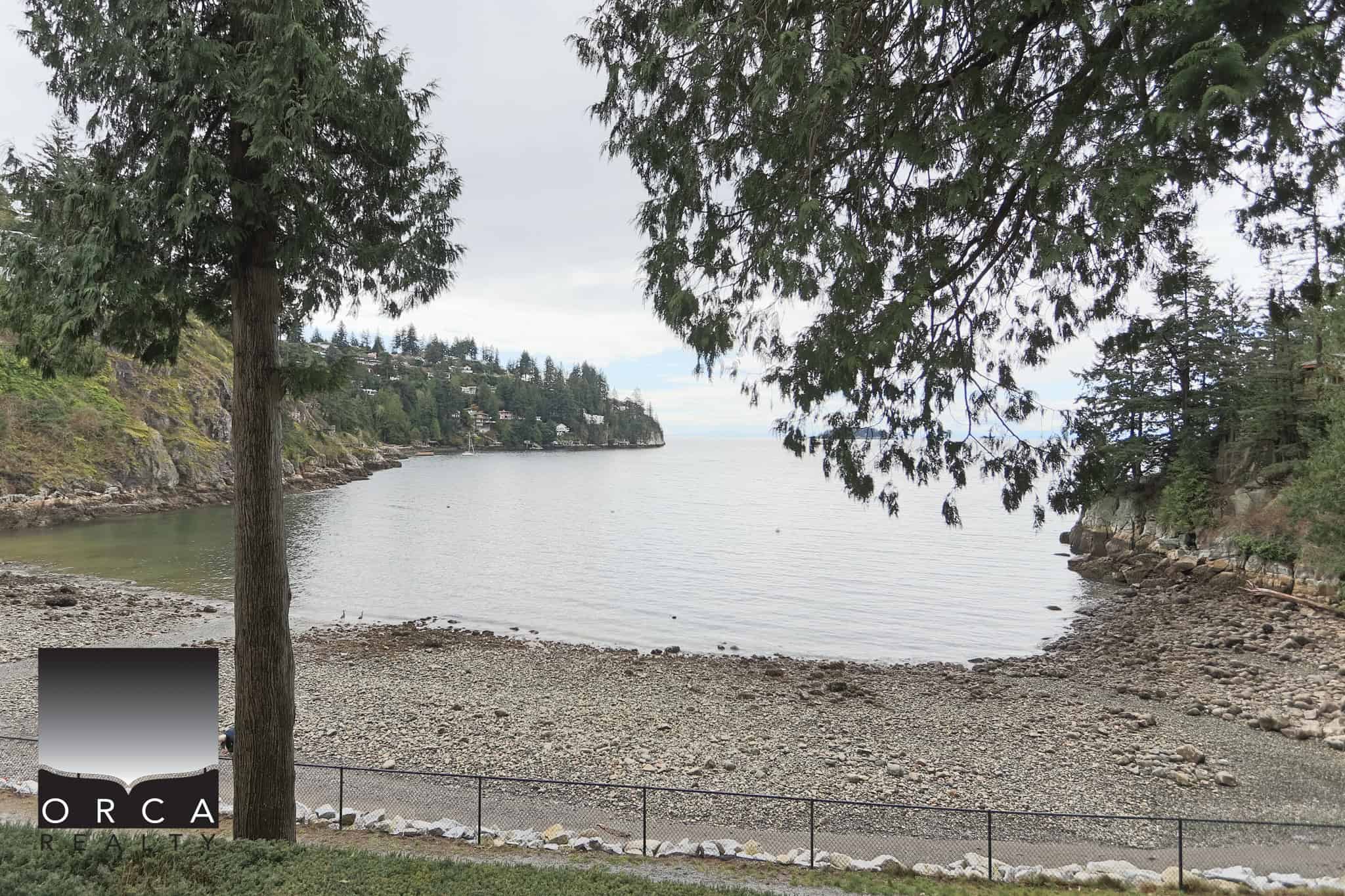 Ocean View from Bachelor Bay Place, West Vancouver Ocean view of Bachelor Bay with trees framing the shoreline in West Vancouver.