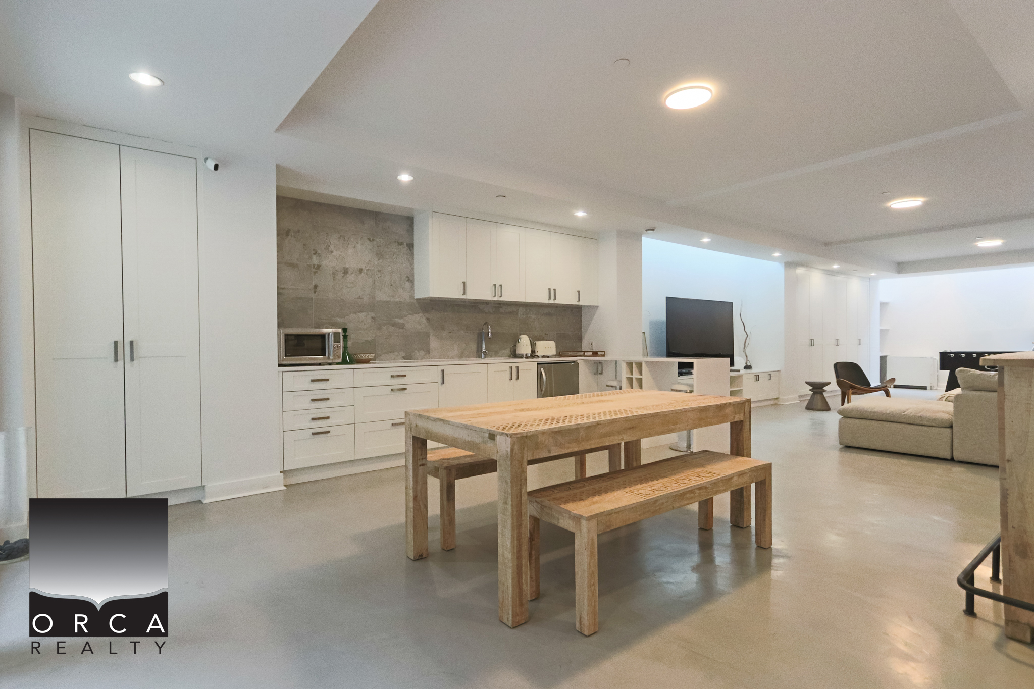Modern West Vancouver Condo Interior Spacious open-concept living area in a West Vancouver condo, featuring minimalist design, sleek white cabinetry, and contemporary furnishings, perfect for luxury urban living.