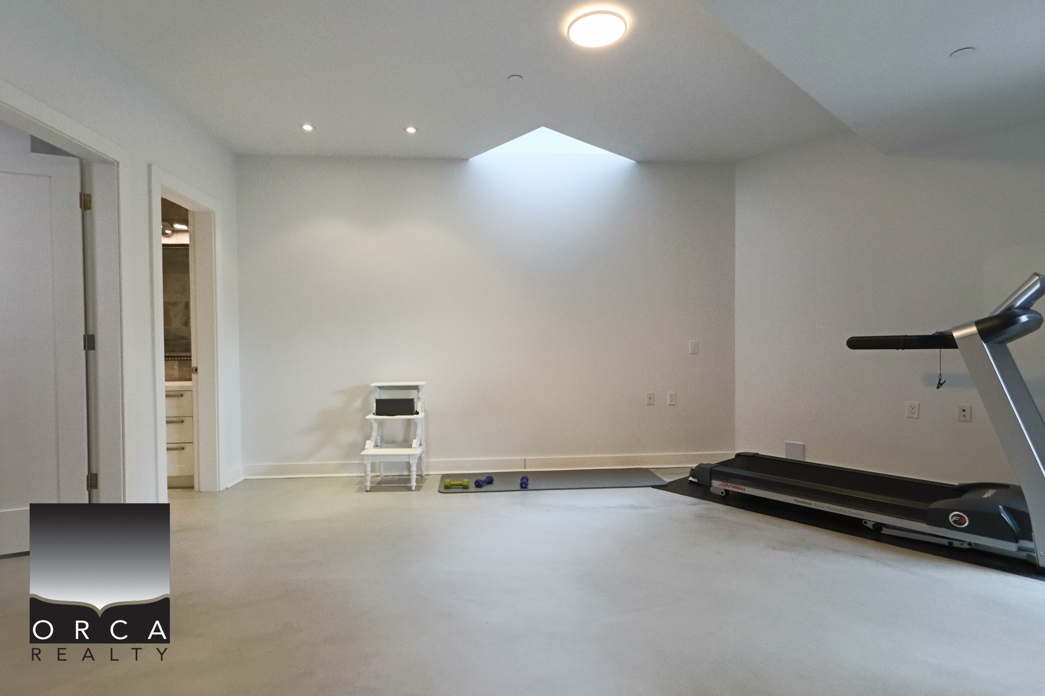 Modern West Vancouver Home Gym Space Indoor home gym with treadmill and minimal decor in West Vancouver residence.