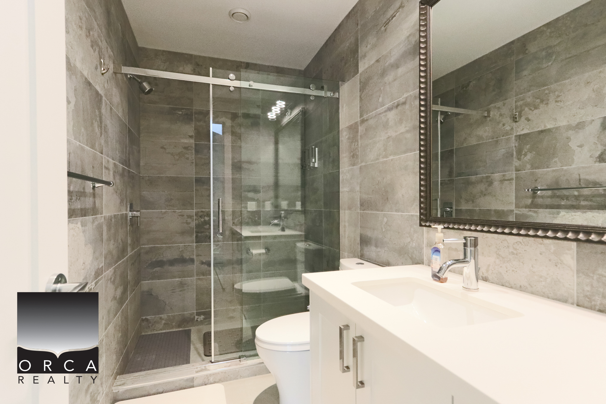 Modern Bathroom with Glass Shower in West Vancouver Bright and contemporary bathroom featuring a glass-enclosed shower, sleek fixtures, and neutral tile finishes, located at 6780 Bachelor Bay Place, West Vancouver.