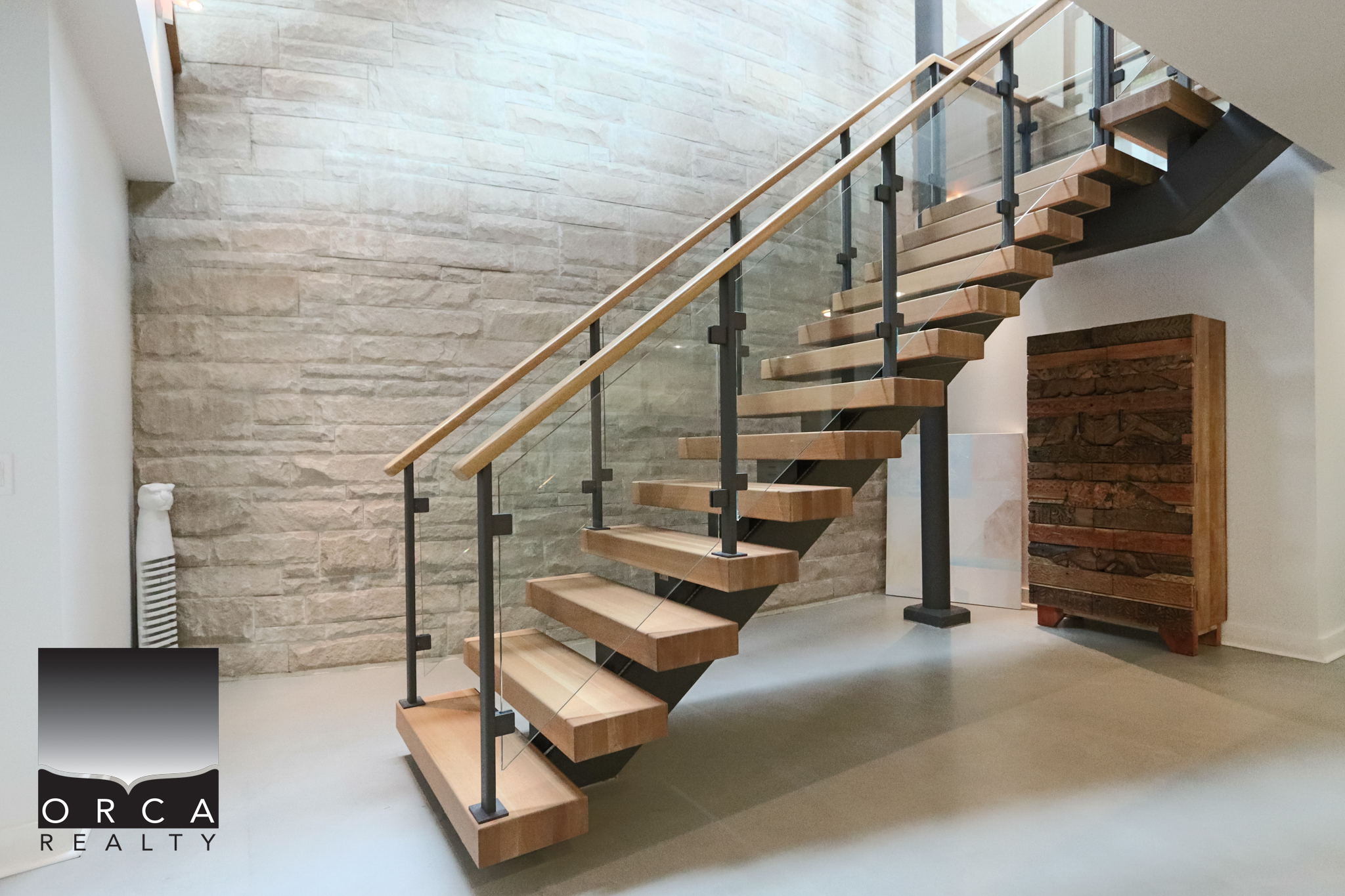 Modern staircase with wooden steps and black metal railing in a West Vancouver home. Elegant interior staircase featuring natural wood treads and sleek black metal balustrades, complementing contemporary West Vancouver home design.