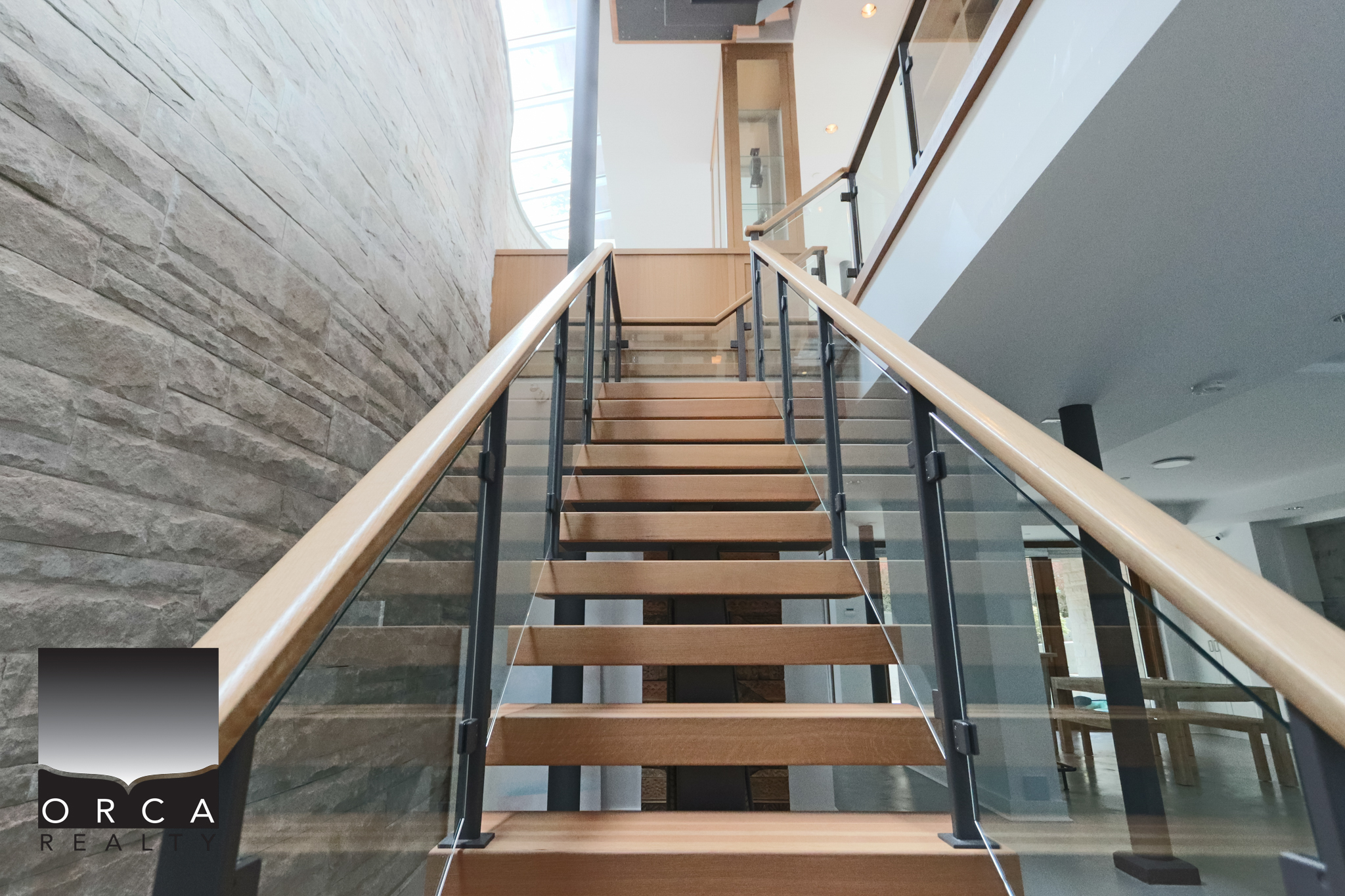 Modern interior staircase at 6780 Bachelor Bay Place, West Vancouver. Elegant staircase with wooden steps and glass railing in a contemporary home.