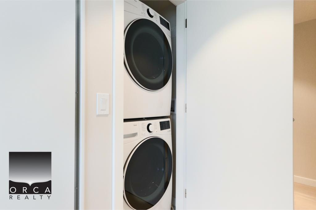 Stacked washer and dryer unit in a contemporary laundry space, showcasing efficient use of space for modern homes. Perfect for homeowners seeking functional and stylish laundry solutions.